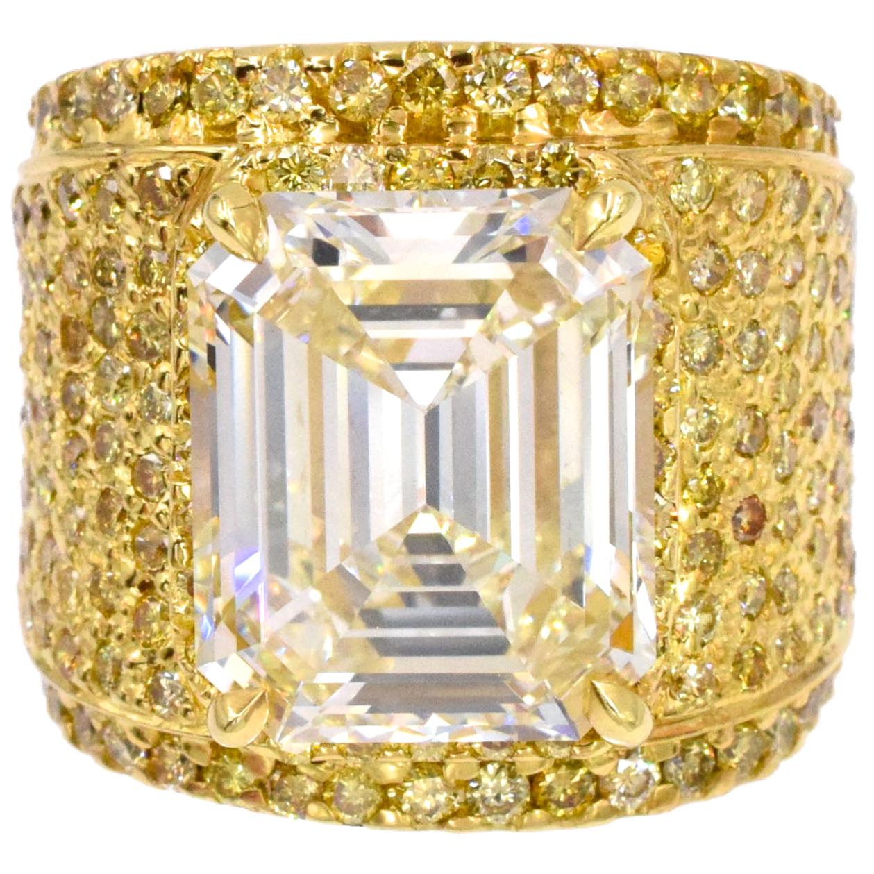 NALLY Impressive Diamond Ring with 10.44 carat emerald-cut diamond. 
G.I.A. certified Champagne Color, ( U-V)  VS2 clarity with 4 carats of yellow round diamonds all set in 18k yellow gold. Finger Size: 8 ( resizable)