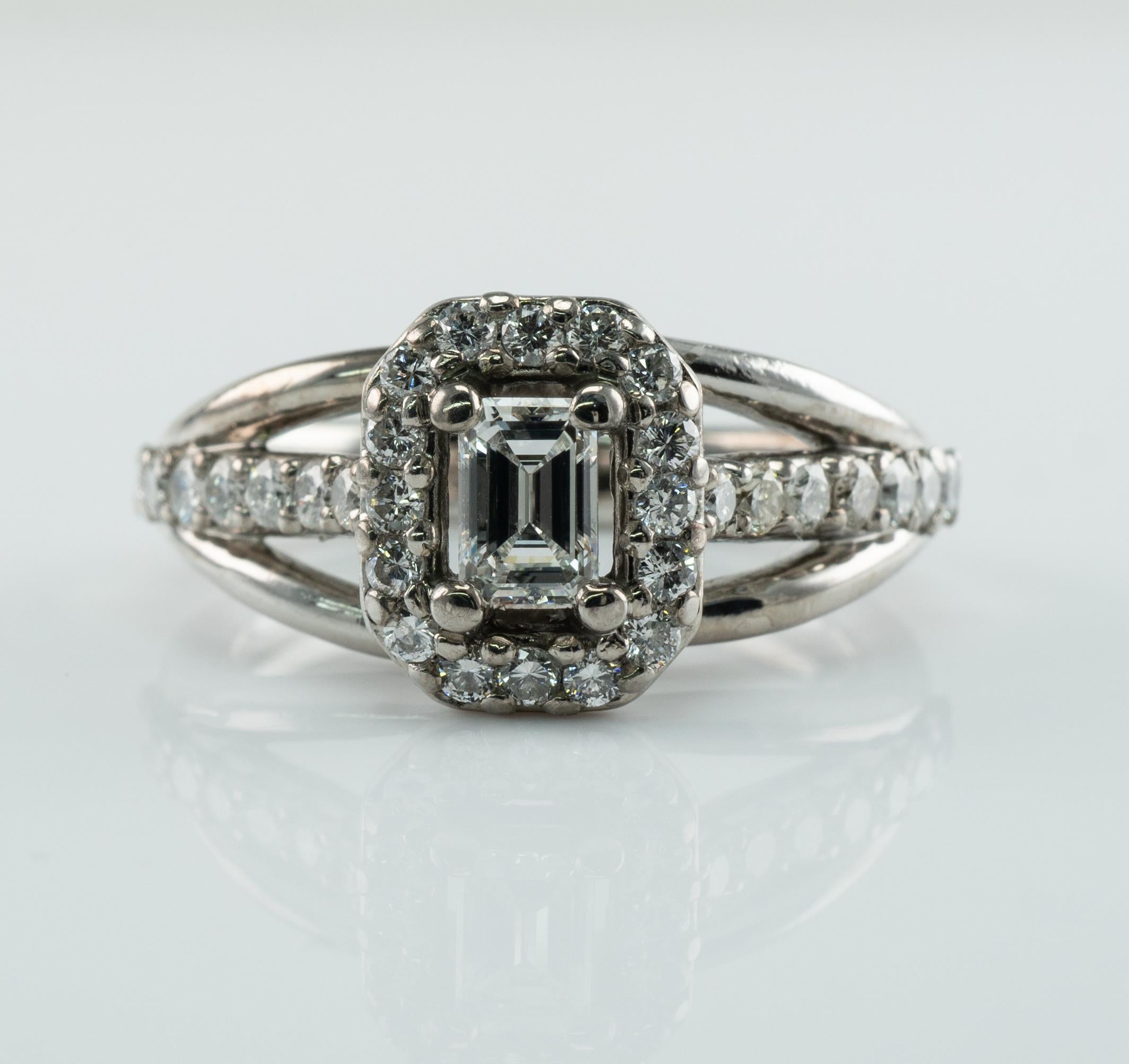 Cette bague de succession ferait une merveilleuse bague de fiançailles ou de mariage. 
Le diamant central de taille émeraude est de 0,23 carat, de pureté VVS2 et de couleur G.
30 diamants de taille ronde de pureté SI1-SI2 et de couleur H.
Le poids