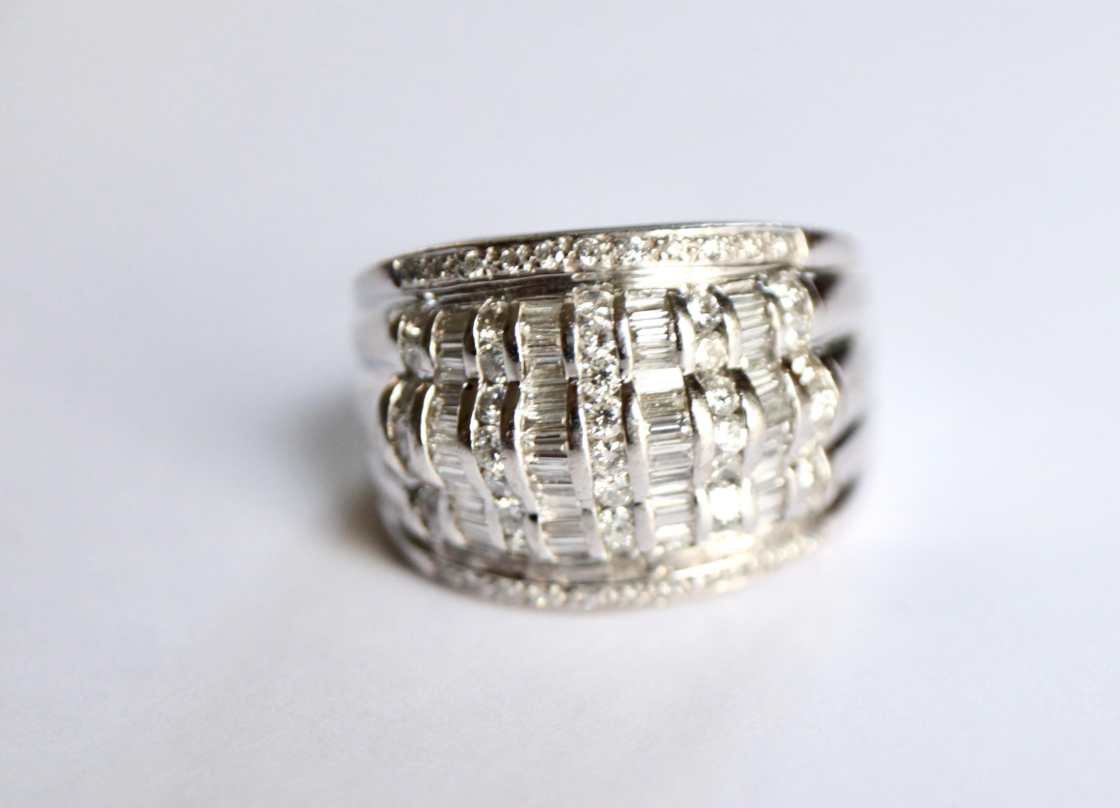 18-karat white gold and diamond ring. Garter ring with 5 rows of round diamonds and 4 rows of baguette diamonds occupying the front of the ring. All of these rows are surrounded by lines of round diamonds on both edges of the ring. Total weight of