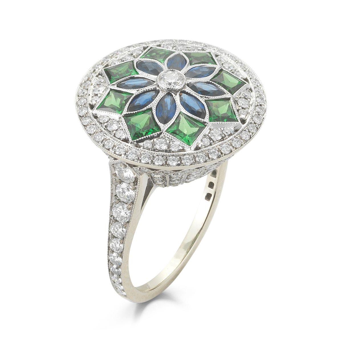 DIAMOND RING
WITH SAPPHIRE AND TSAVORITE
Custom cut Tsavorites and Sapphires form a stained glass appearance
in this beautiful statement ring.
Item: # 02683
Metal: 18k W
Color Weight: 2.39 ct.
Diamond Weight: 1.96 ct.