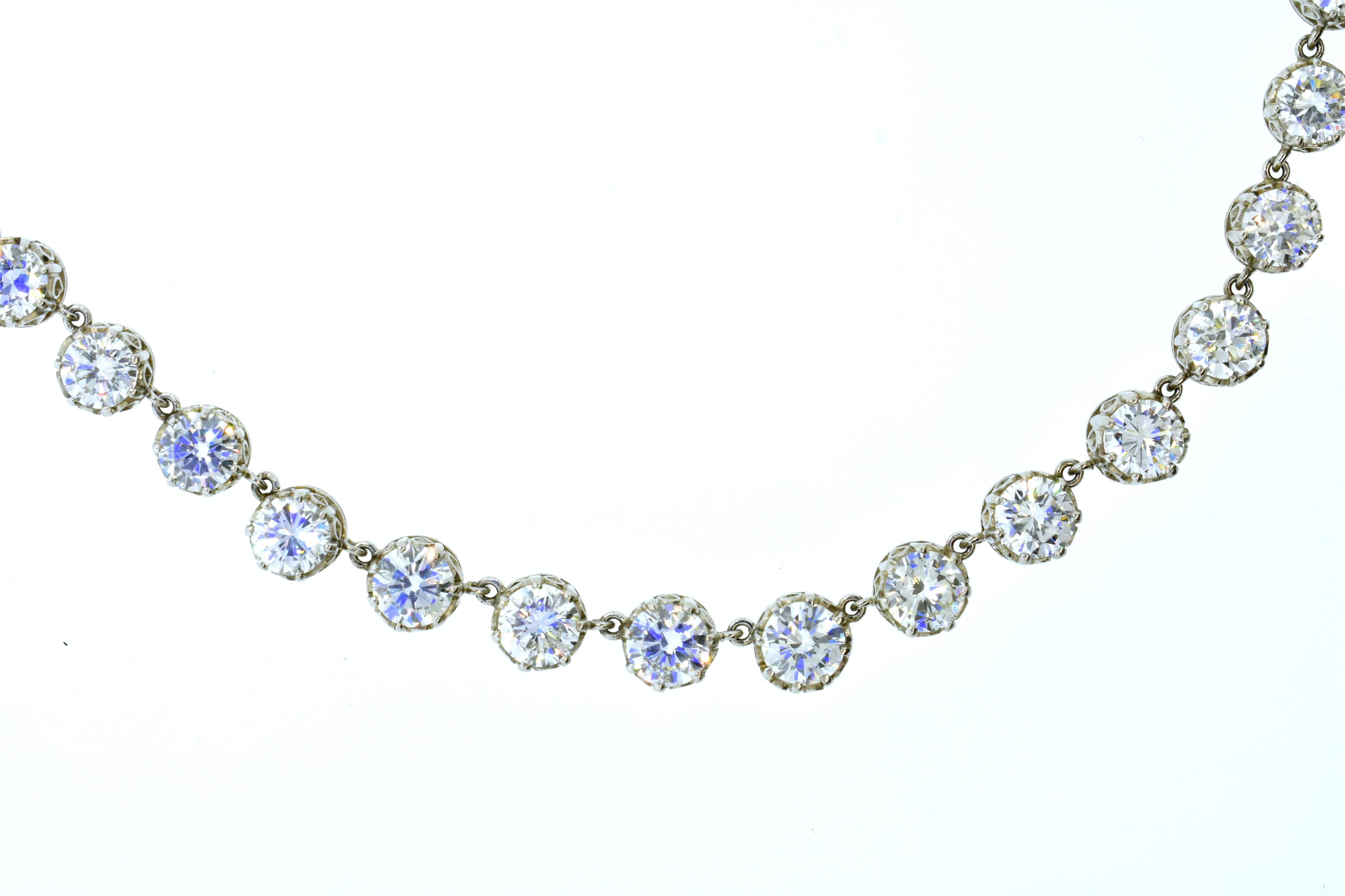 Antique diamond Rivere necklace possessing fine white diamonds.  The diamonds have a very slight graduation with the smaller diamonds set at the diamond clasp and graduating up in size to the center of this graceful diamond statement.  There are 52 