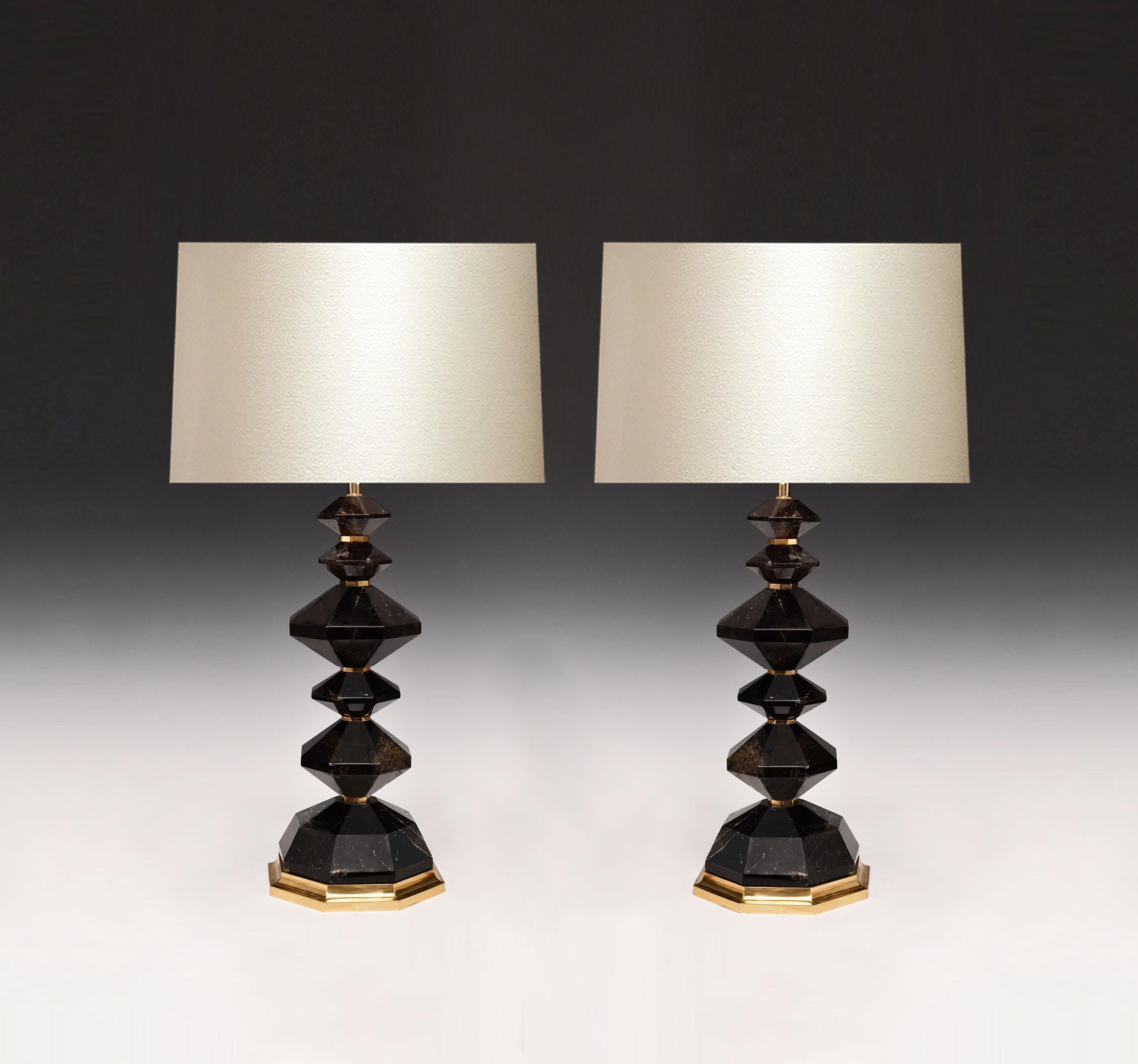 A pair of carved dark diamond rock crystal lamps with polish brass decoration. Created by Phoenix Gallery, NYC.
Custom size and quantity upon request.
To the rock crystal: 19.25 in/H.
(Lampshade not included).