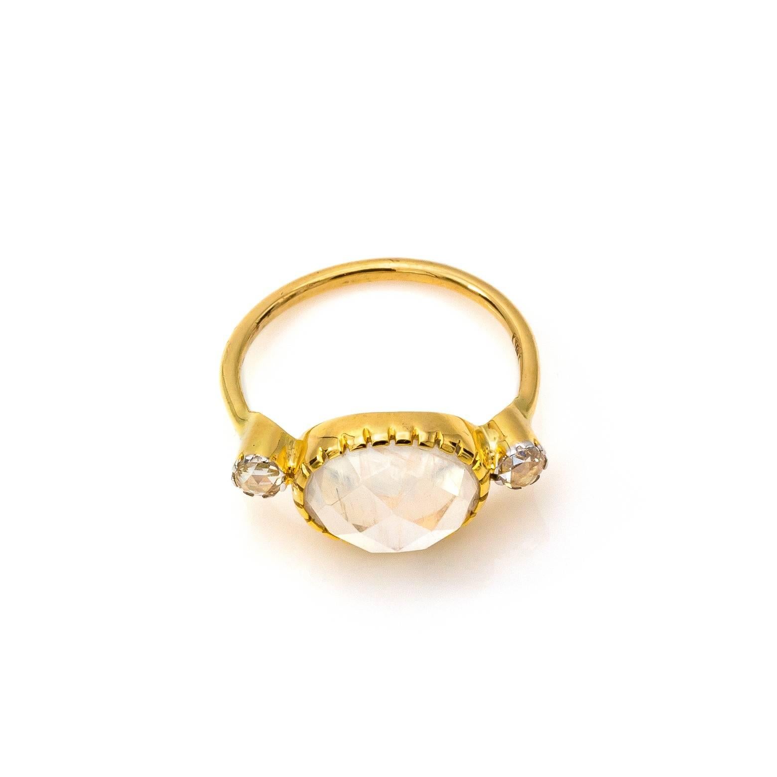 The bright whites sparkle with moonstone and diamonds in 18K yellow gold. The intricate bezel adds style and flare creating a regal look fit for a goddess. The high carat yellow gold with the celestial faceted stones are mesmerizing and magical. The