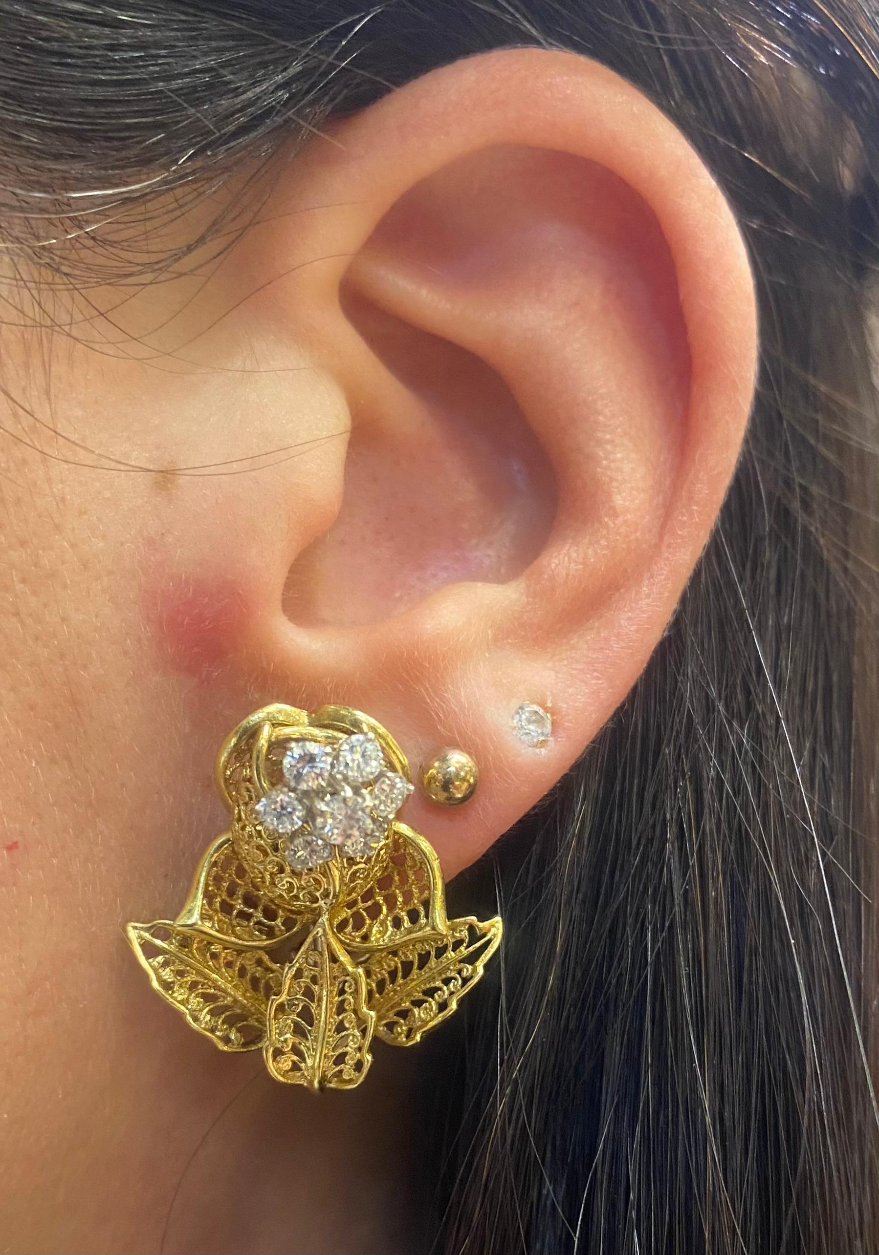 Diamond Rose Flower Earrings

A pair of earrings consisting of 14 round cut diamonds weighing approximately 1.10 carats. With a delicate 18 karat yellow gold floral motif.

Back Type: clip on

Measurements: 1