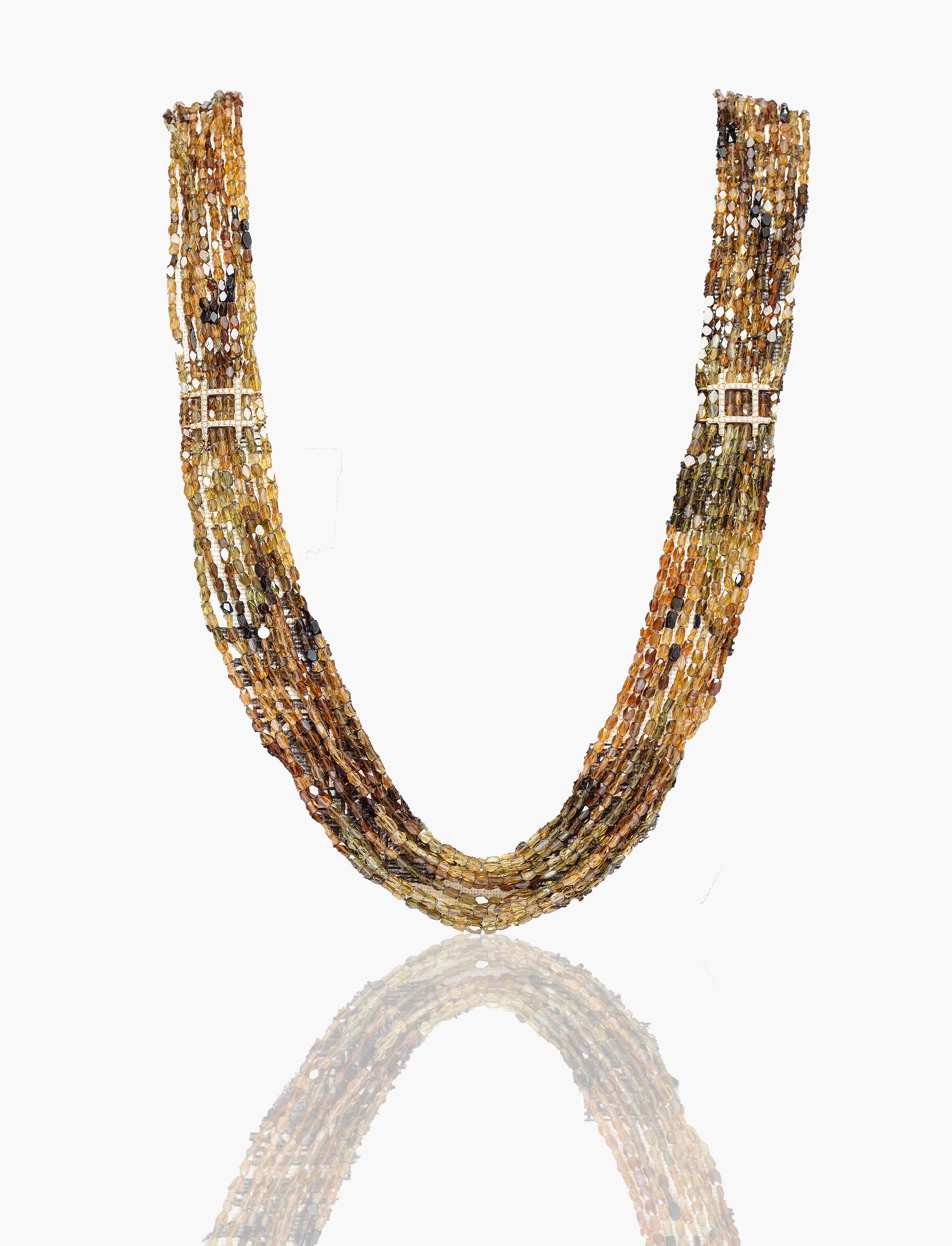 Beautiful faceted and sparkling natural tourmaline  stranded sautoir set with two 18 Karat red gold and white diamonds square motifs.
The refined palette of earth golden yellow, orange,  green olive and dark brown has a grounding effect as do all