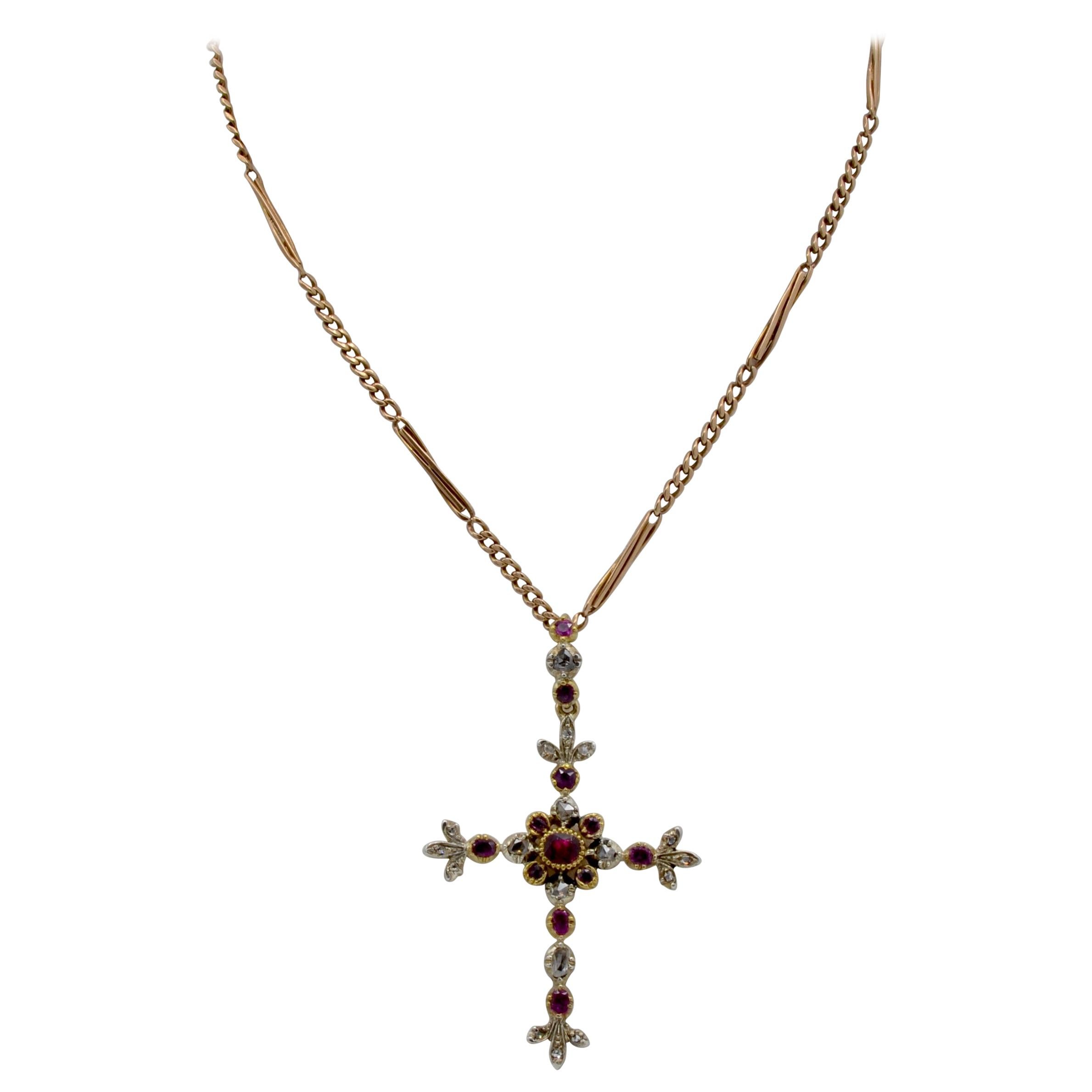 This Victorian cross is beautifully embellished with Diamonds ( 0.28 ct tw aprox. ) and rubys (0.38 ct tw aprox.). It perfectly balanced with diamond plums at each end as well as a stone encrusted bale to add a chain of your choice or a black silk