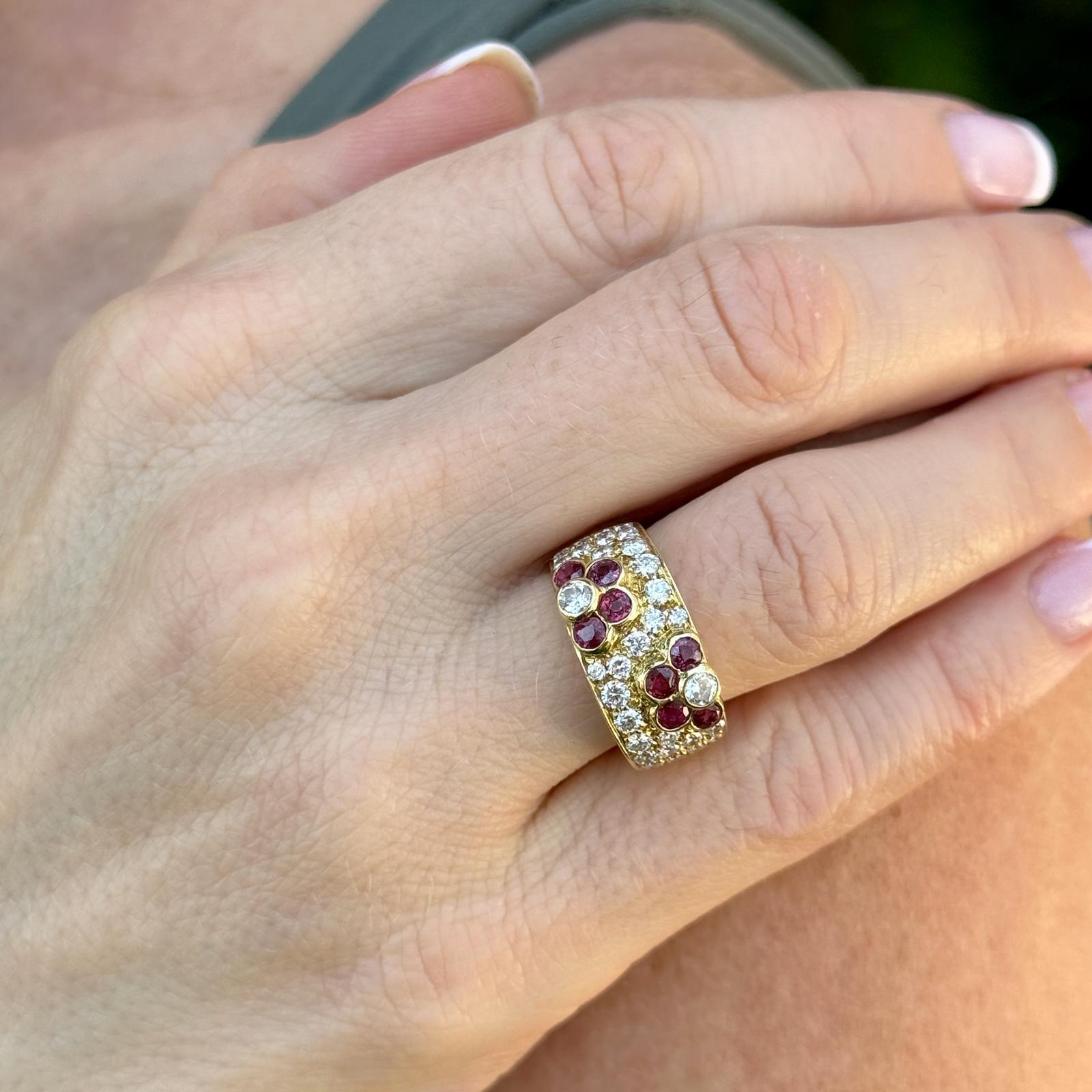 The modern diamond ruby floral design 18 karat yellow gold band ring is a stunning piece of jewelry that seamlessly blends elegance with contemporary flair. It features 31 genuine diamonds and 8 rubies meticulously set within the gold band, adding