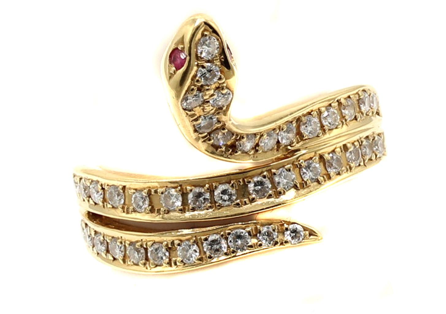 Bague serpent en or jaune 18 carats magnifiquement conçue et réalisée de main de maître. Serti de diamants ronds de taille brillant d'un blanc éclatant et de deux petits rubis pour les yeux du serpent, le serpent s'enroule autour du doigt en levant