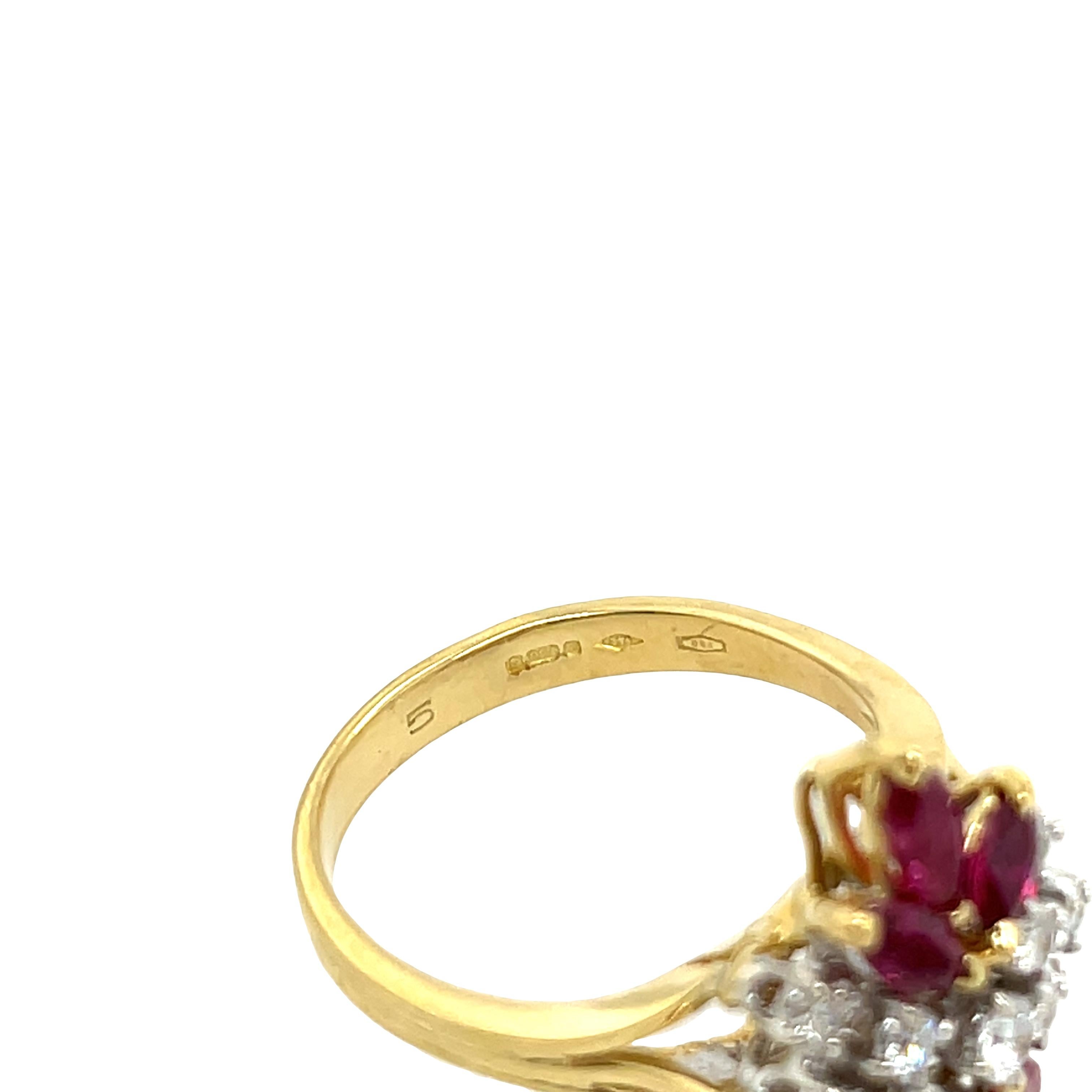 A striking cluster ring set in 18ct yellow and white gold, featuring a vibrant marquise cut rubies surrounded by sparkling natural diamonds. The contrasting tones of yellow and white gold enhance the brilliance of the diamonds while complementing