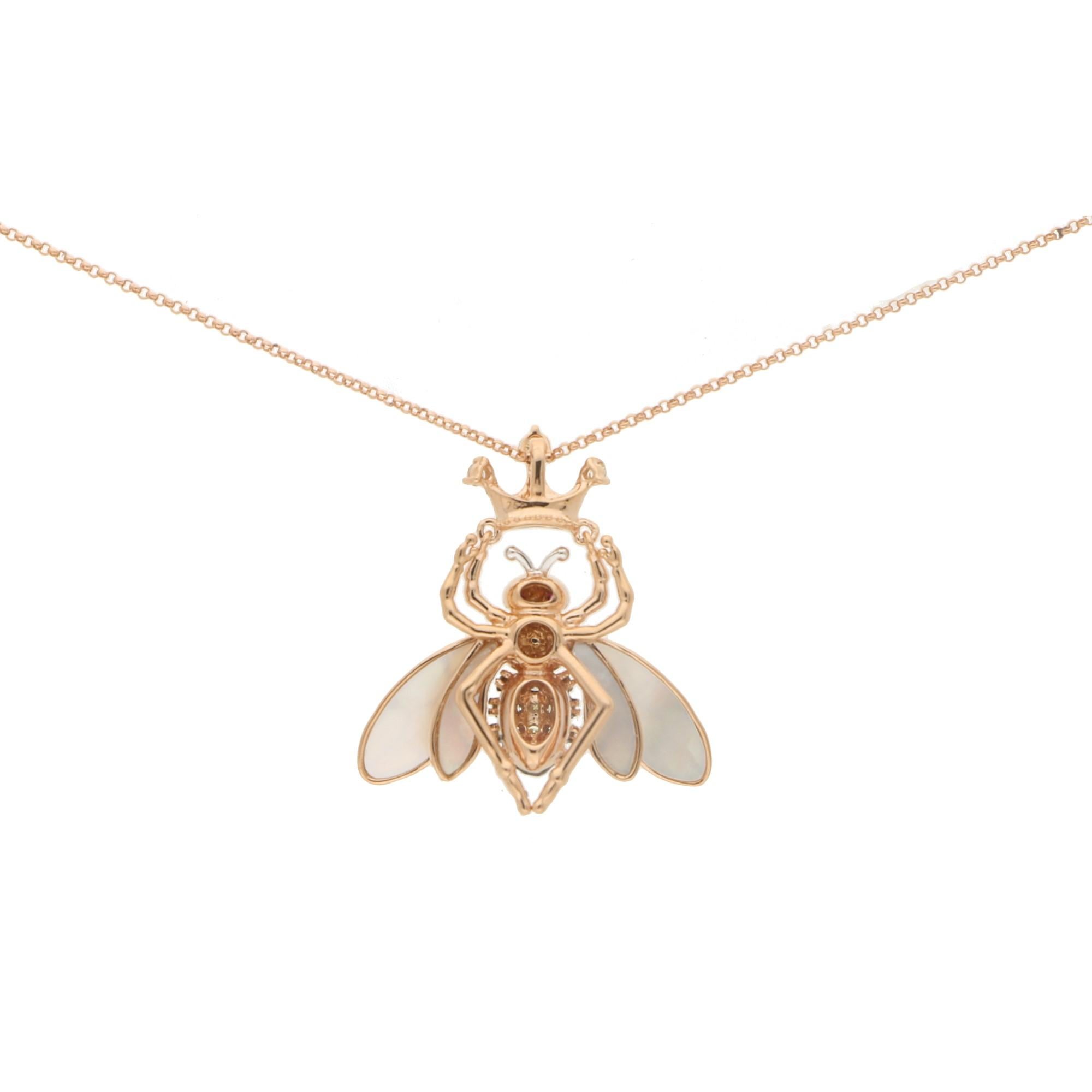 A charming Queen Bee pendant set in 18k rose gold. 

The necklace is predominantly set with a central rose gold bee which is set throughout with white and black round brilliant cut diamonds amongst a black enamel inlay. It is then set with two round