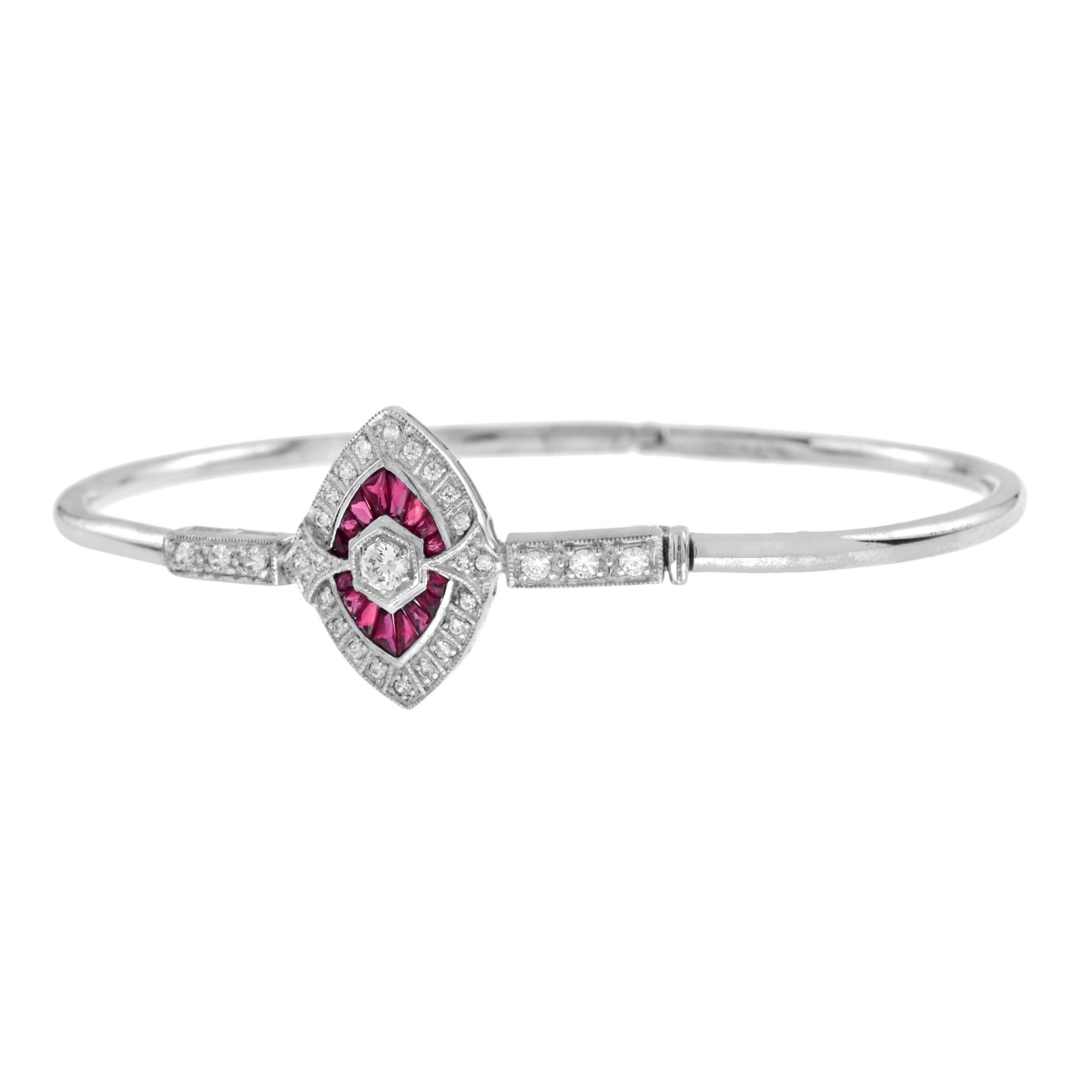 This chic, sleek and sophisticated bangle bracelet centers on the round brilliant diamond and French-cut ruby, punctuated on each side by three round diamonds. A truly superb and stunning Art Deco jewel. 14k White Gold. 
Bracelet Information
Style: