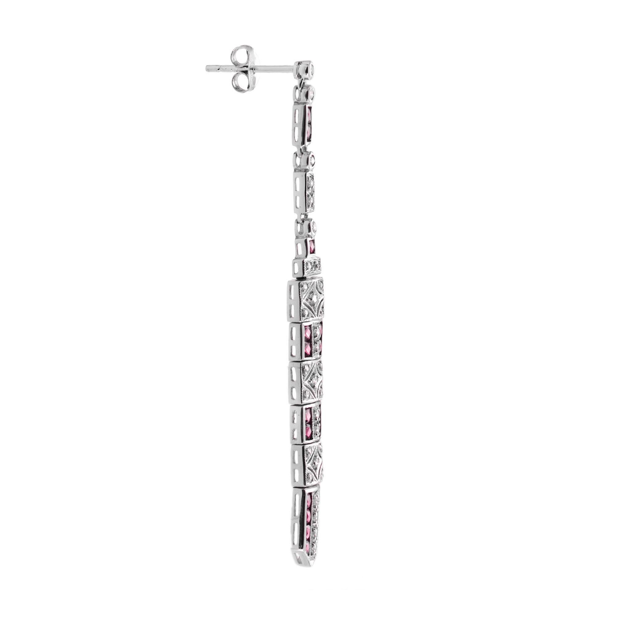 These art deco bar dangle earrings are the epitome of vintage-inspired elegance featuring mesmerizing geometric patterns feature with ruby and diamonds. 14K White Gold. 
Information
Style: Art Deco
Width: 6 mm.
Length: 62 mm.
Weight: 7.90 g.