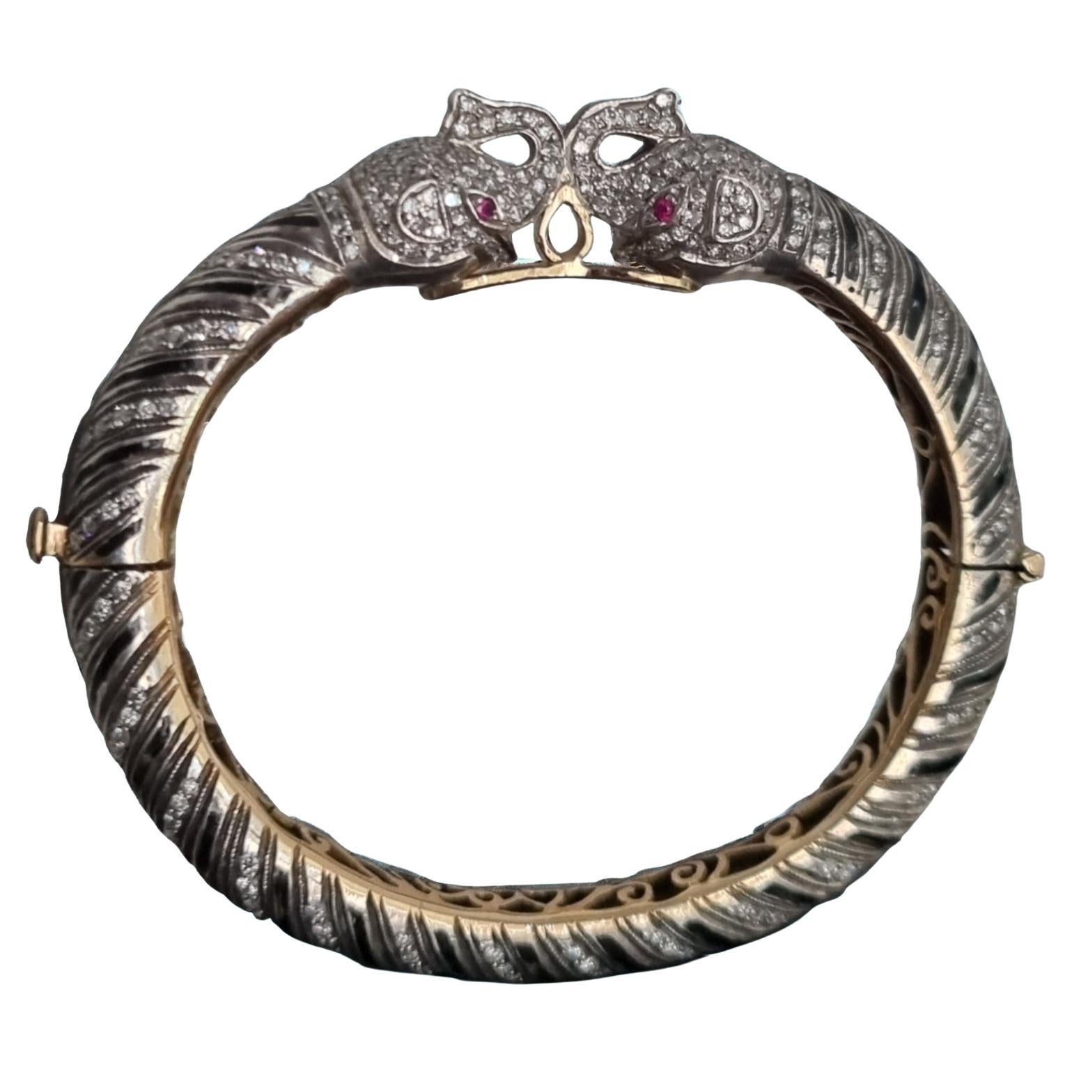 Diamond, Ruby, Black Enamel Elephant Heads Bangle Bracelet (First quarter 20thC) For Sale