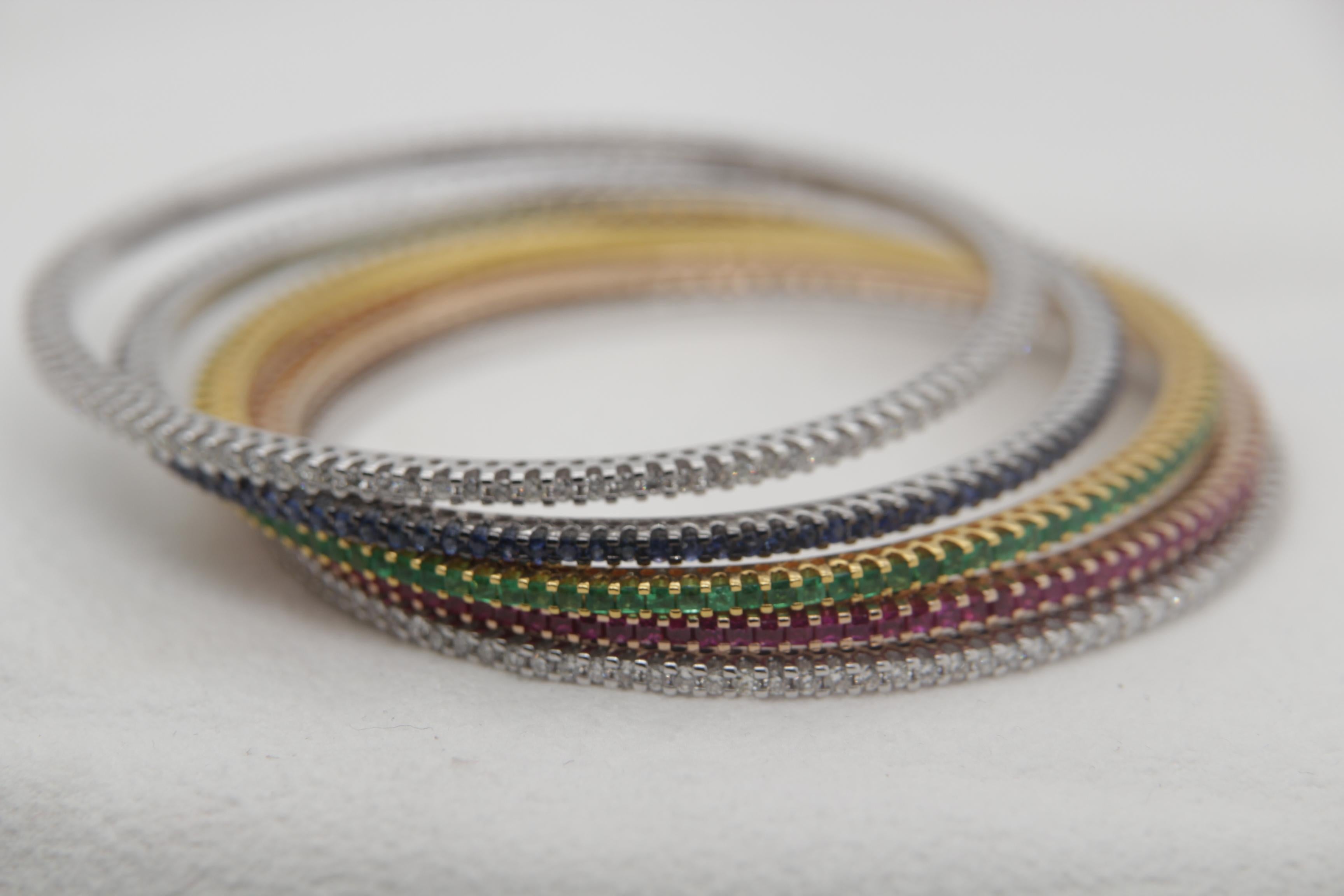 A brand new diamond, ruby, blue sapphire and emerald bangle in 18 karat gold. These are five bangles. The total diamond weight is 3.88 carat. The total ruby weight is 4.10 carat, blue sapphire weight is 2.52 carat and emerald weight is 3.02 carat.