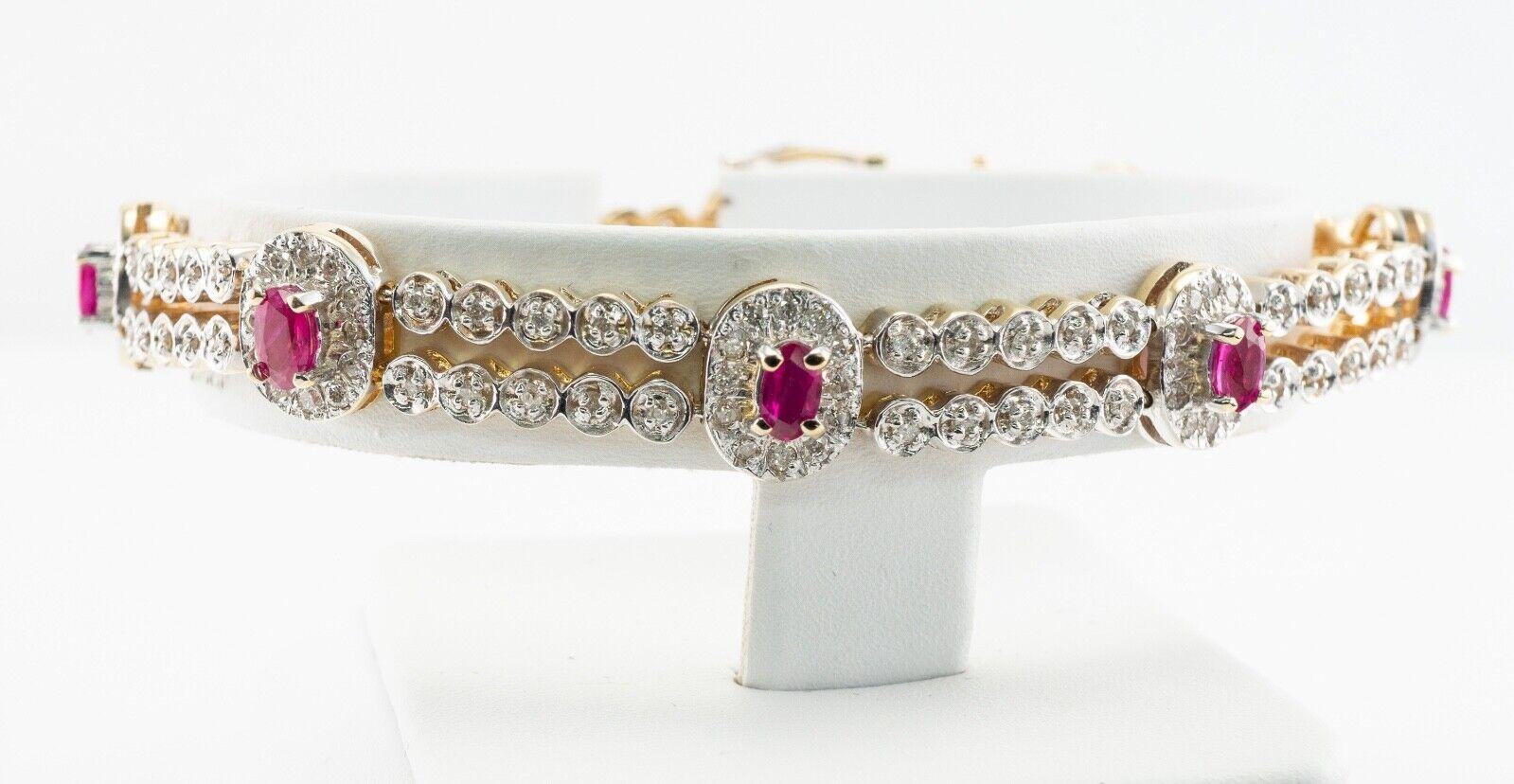 This terrific estate bracelet is finely crafted in solid 14K White Gold for the top and Yellow Gold for the back, and set with natural Earth mined Rubies and Diamonds. There are 8 oval cut Rubies in this bracelet totaling 2.80 carats. The rubies are