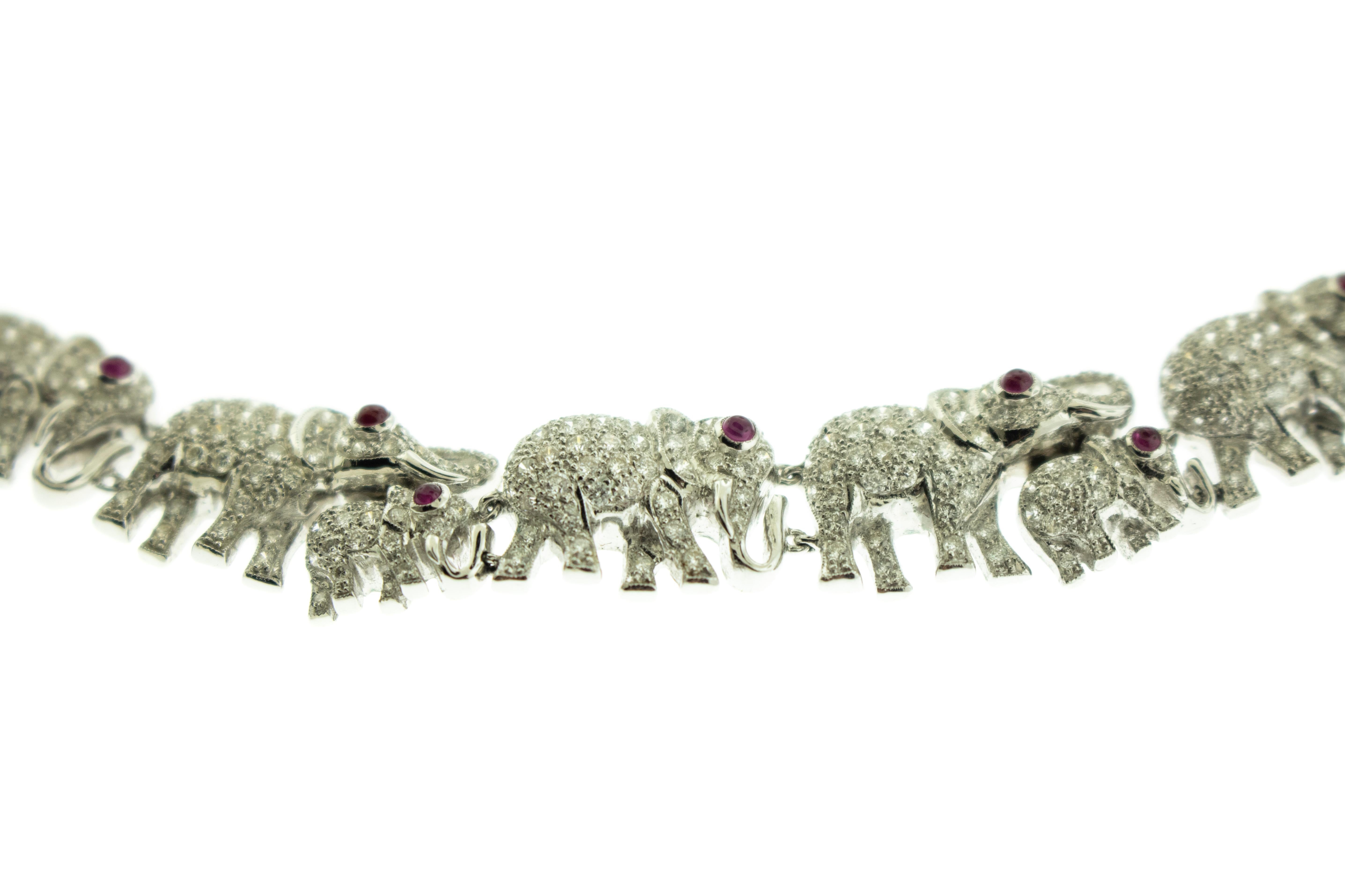 Diamant Rubin Elefant 18k Weißgold Armband Halskette Set. Das Set ist mit Baby- und erwachsenen Elefanten mit Rubinaugen und mit Diamanten besetzten Körpern verziert. Das Gesamtgewicht des Sets beträgt 110,60 Gramm. 
Länge des Armbands 7 Zoll. Länge