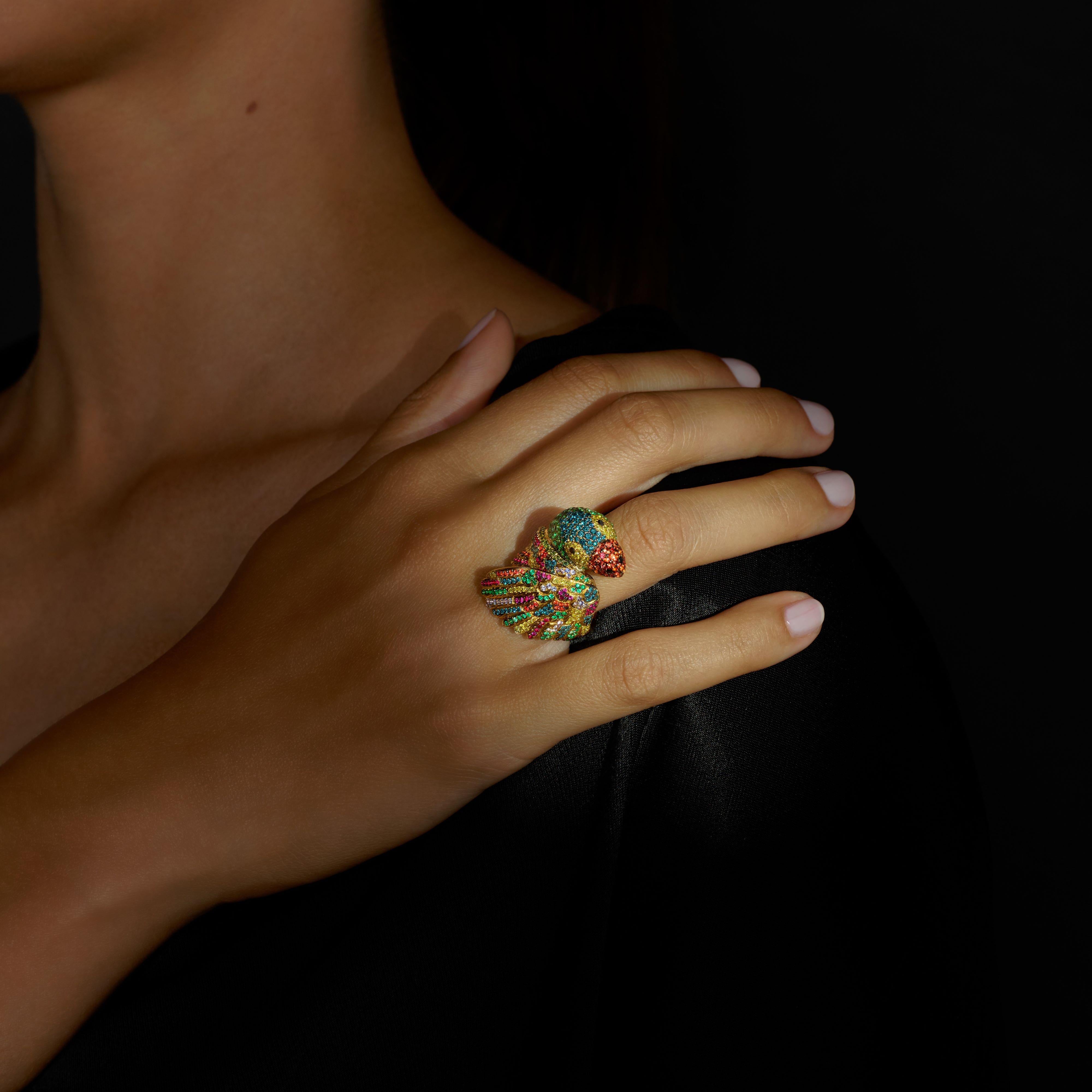 Rosior one-off Cocktail Ring set in Yellow Gold with:
- 215 emeralds weighing 1,65 ct;
- 127 Blue Diamonds weighing 0,74 ct;
- 92 Orange Sapphires weighing 0,72 ct;
- 87 Yellow Diamonds weighing 0,42 ct;
- 57 Rubies weighing 0,33 ct;
- 52 Purple