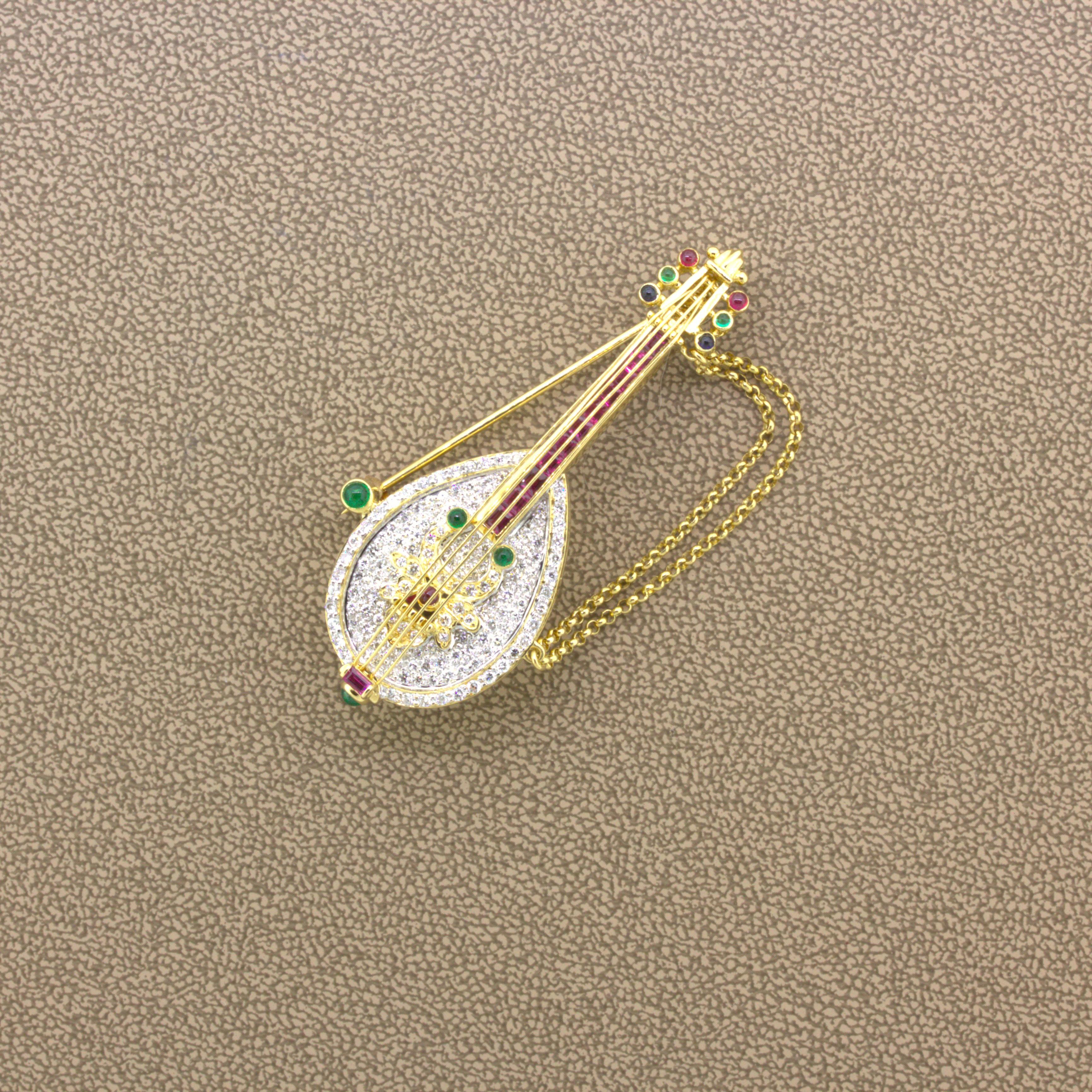 A fun and stylish brooch of a diamond and gemstone set golden mandolin! It features 0.97 carats of bright white round brilliant-cut diamonds along with 1.19 carats of vivid red rubies set under the mandolin strings. Adding to that are 0.32 carats