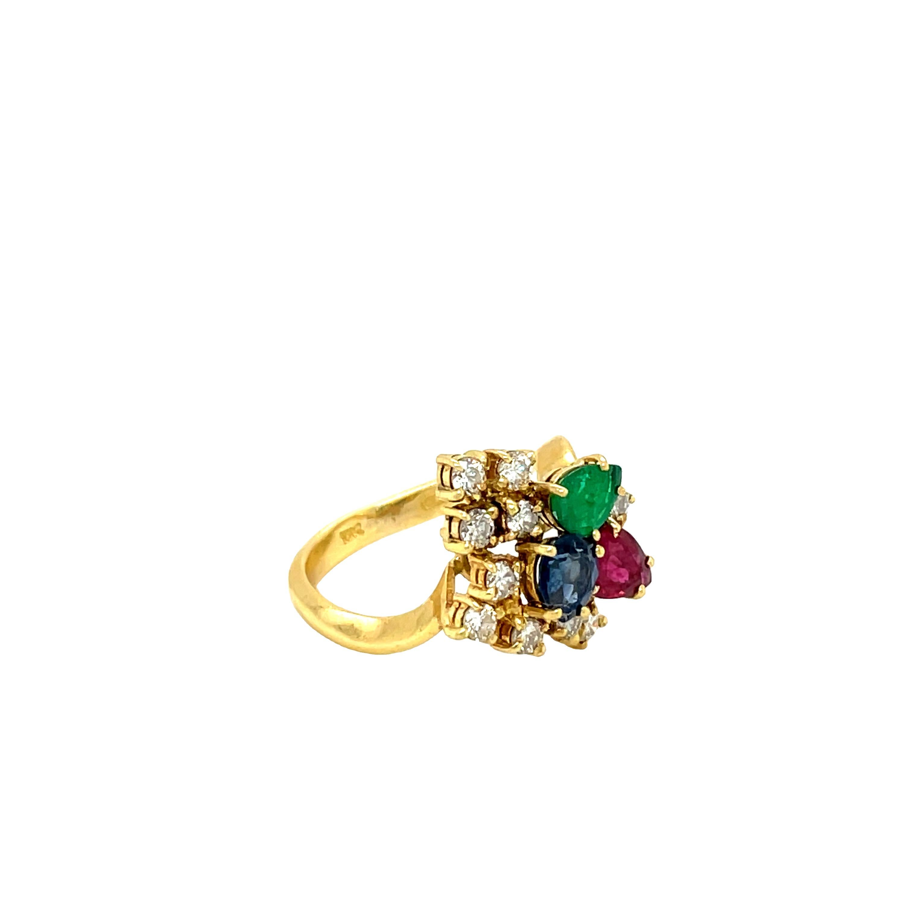 This stunning and impressive gemstone cluster ring has been crafted in 18k yellow gold featuring ten round brilliant cut diamonds weighing approx. 0.80 carats, G-H color, VS clarity,  one pear shape ruby, one pear shape sapphire, one pear shape