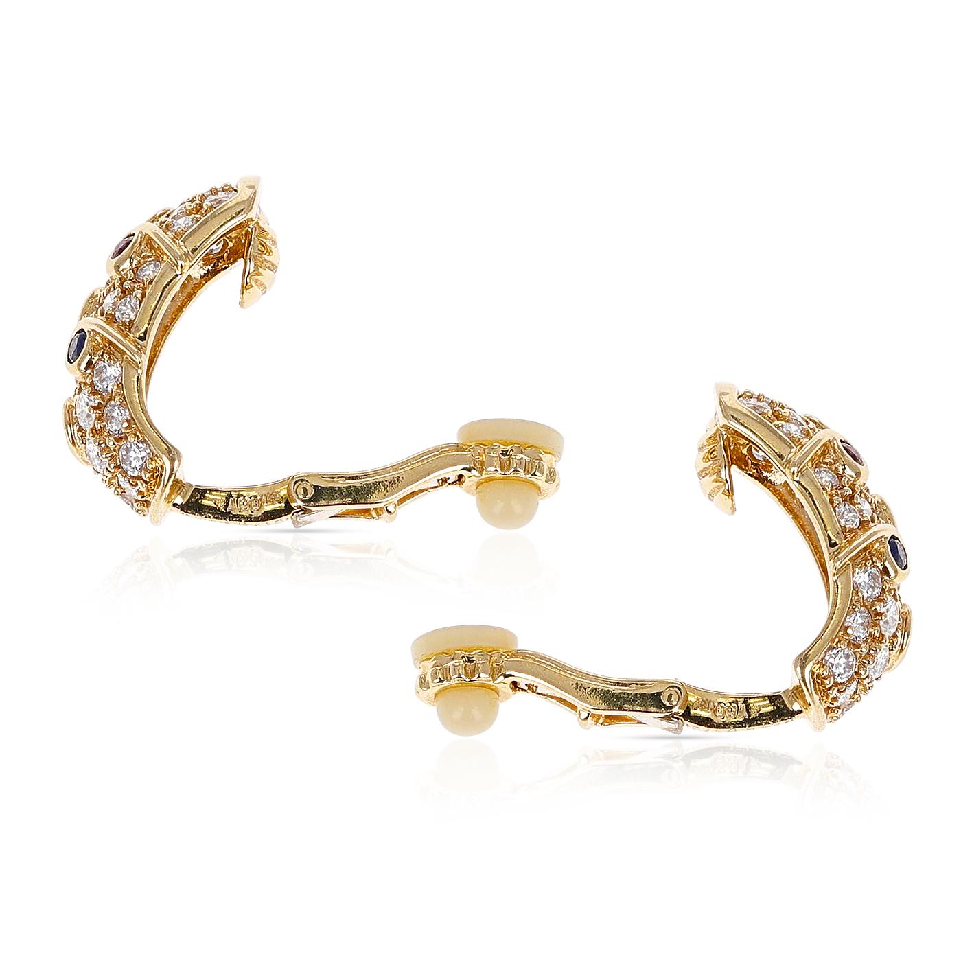 A pair of Cocktail Earrings with Diamonds, two Rubies, One Emerald, Two Sapphires each made in 18 Karat Yellow Gold. The total weight of the stones is 1.79 carats. The earrings are clip-ons. The length is 0.60 inches. The total weight is 10.70