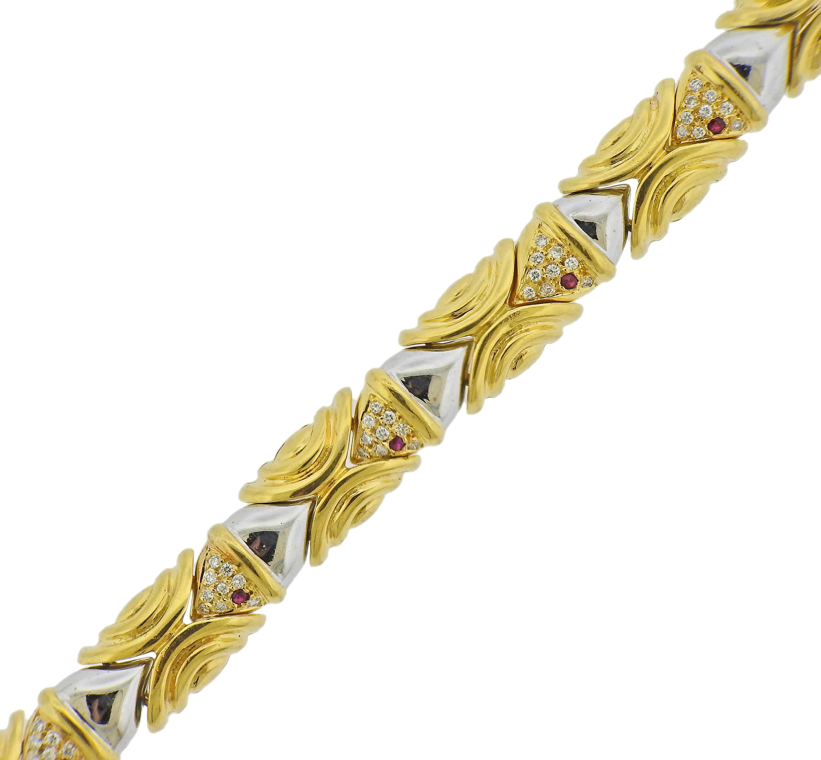 18k white and yellow gold fish motif bracelet, set with approx. 0.72ctw in diamonds and ruby eyes. Bracelet is 7 1/16