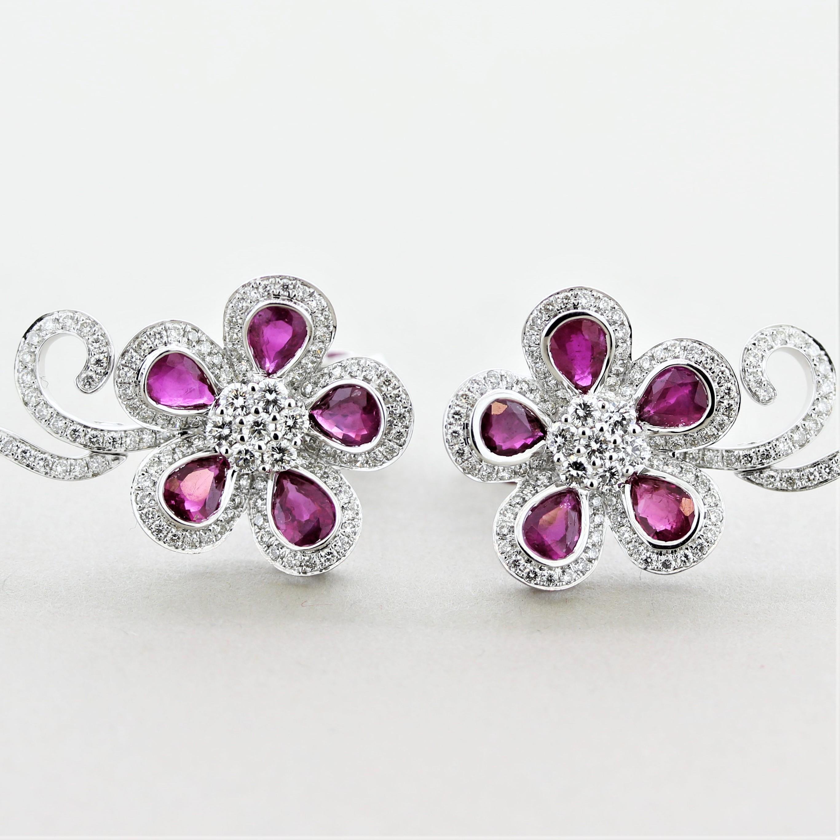 A fun and stylish pair of earrings. They feature vivid red pear-shaped rubies weighing a total of 3.42 carats along with 1.53 carats of round brilliant-cut diamonds. The stones are set over 18k white gold in a floral design.

Length: 1.25 inches
