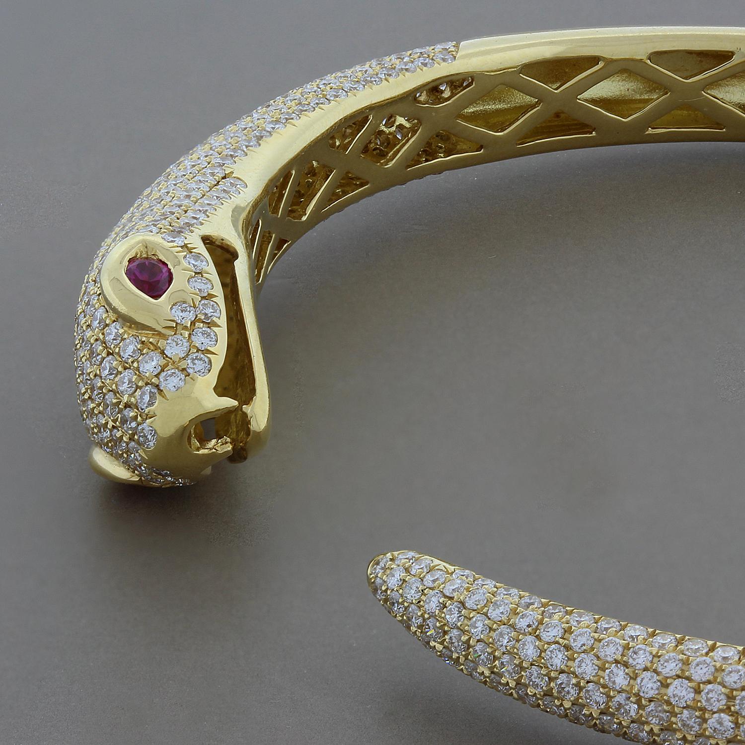 This hissing snake features 2.63 carats of round pave diamonds with 0.11 carats of ruby eyes. Set in 18K yellow gold, this cuff opens with ease as it is comfortable.

Fits wrists up to 6 inches
