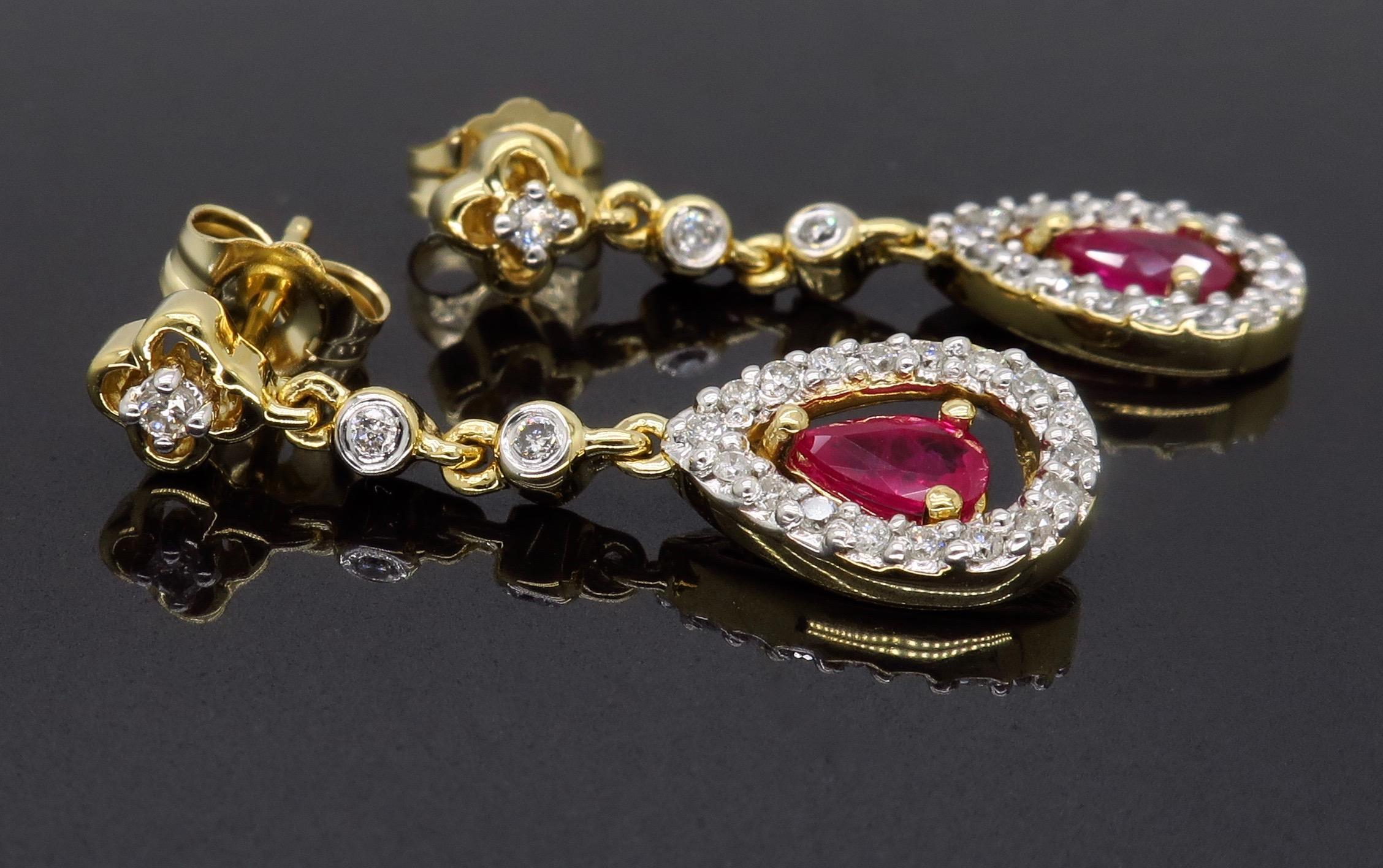 Ruby earrings complimented by a halo of Round Brilliant Cut diamonds.

Gemstone: Ruby  & Diamond
Gemstone Carat Weight: Approximately 4.3x2.9mm Pear Shaped
Diamond Cut: Round Brilliant Cut Diamonds
Average Diamond Color: G-J
Average Diamond Clarity: