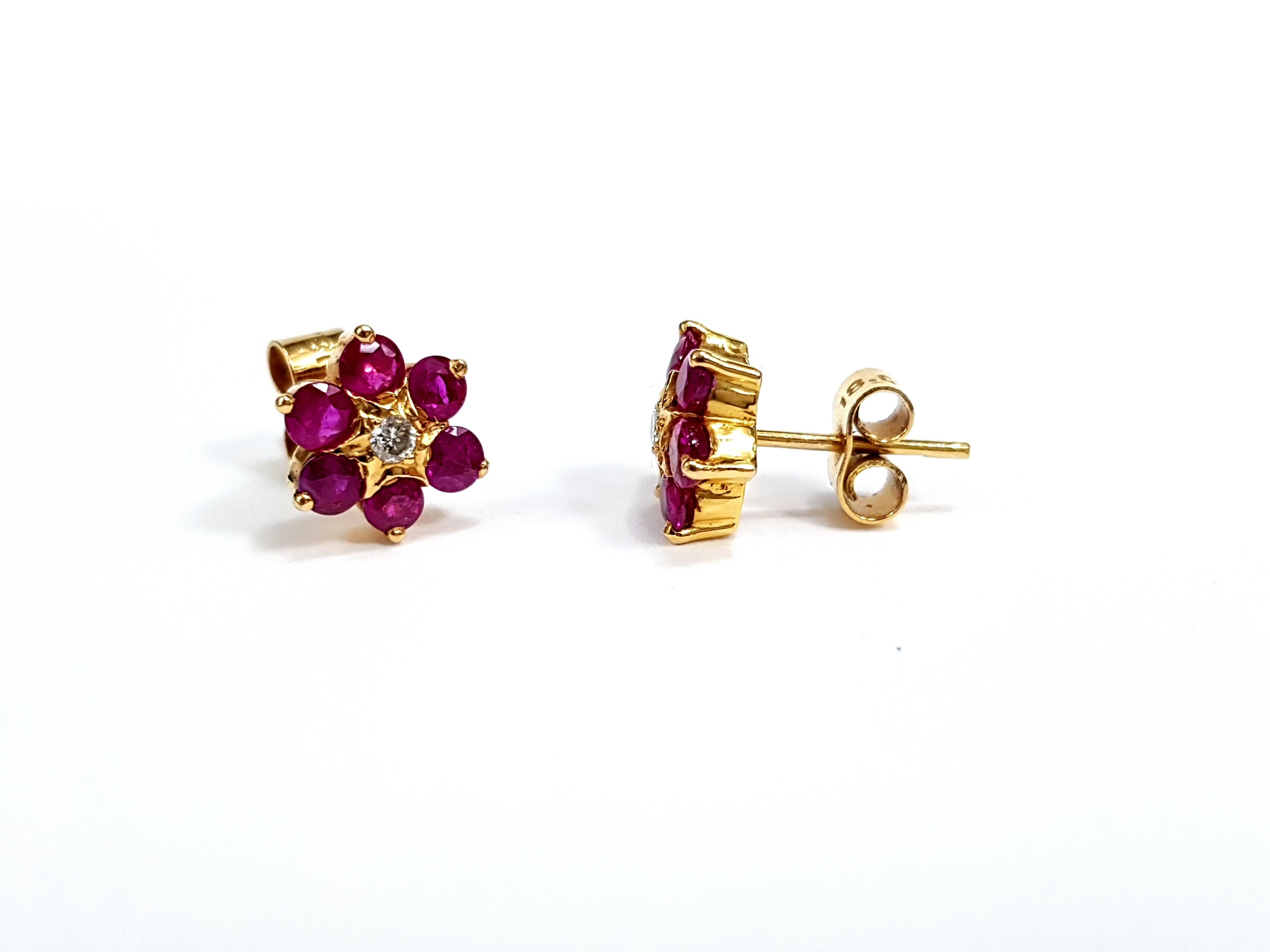 Diamond Ruby hand made daisy flower 18 Karat yellow gold cluster Artisan stud earrings.
An exquisite ruby and diamond earrings, set in 18 karat yellow gold handmade cluster. Each has a center diamond surrounded by six beautiful pinkish red Rubies in