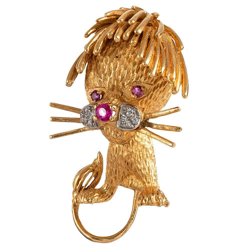 Bestow upon the lion or lioness in your life the gift of this most charming brooch, his textured fur and golden mane made of 18 karat yellow gold and the features of his adorable face highlighted by rubies and white diamonds. Note his sweet whiskers