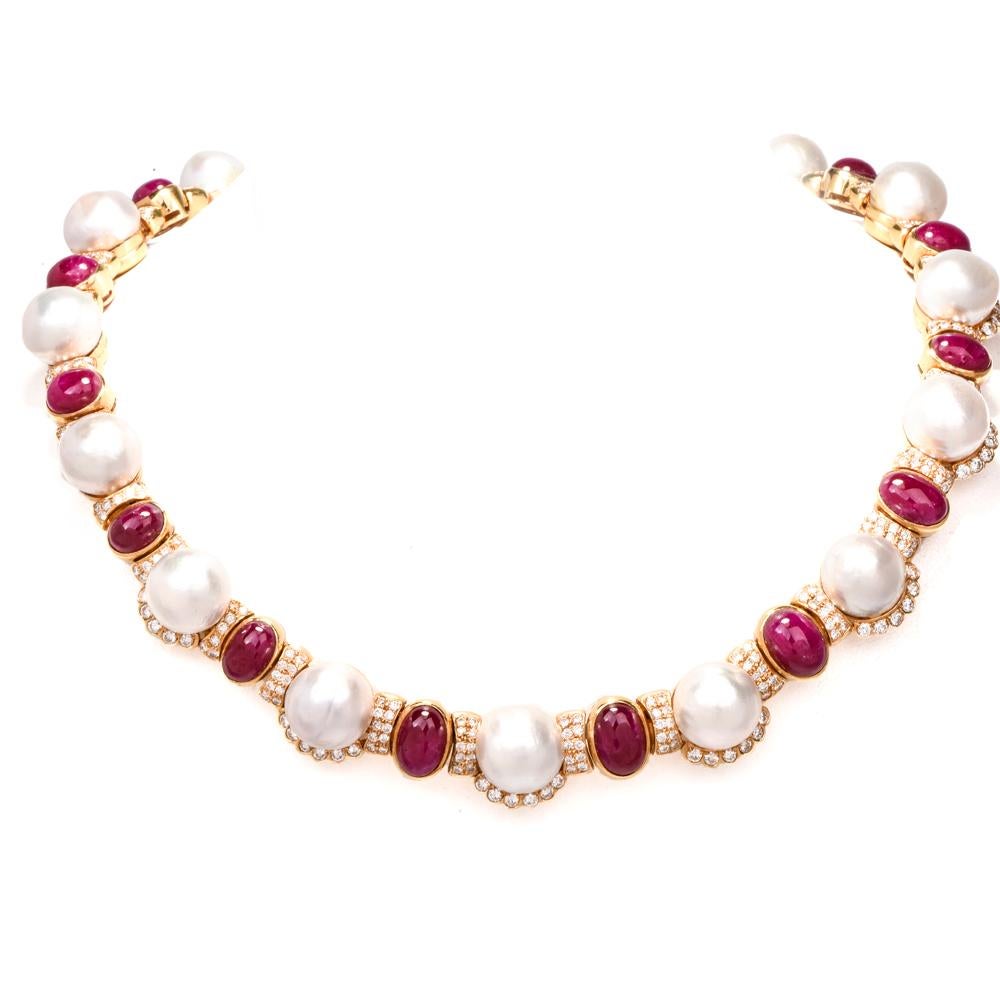 This beautifully designed estate diamond, ruby, pearl choker necklace is crafted in solid 18K yellow gold and weighs 173 grams. The necklace showcases an exquisite series of 16 genuine white pearls 13.5 to 12.5 mm in diameter, 245 round-cut diamonds