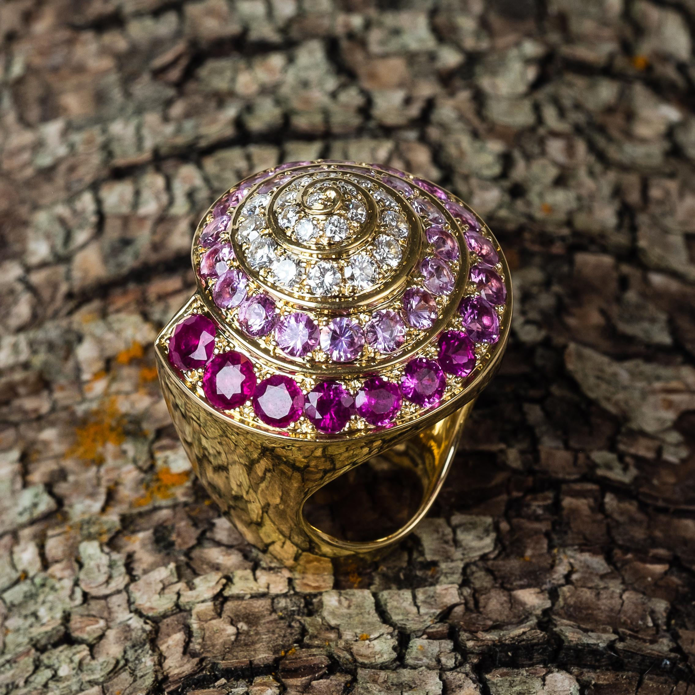 Designed as an ombré circular-cut ruby, pink sapphire and diamond shell ring, mounted in 18K gold.

Description:
Gem details: 20 circular-cut diamonds weigh approximately 0.82 cts., 7 circular-cut rubies weighing approximately 1.92 cts. and 25