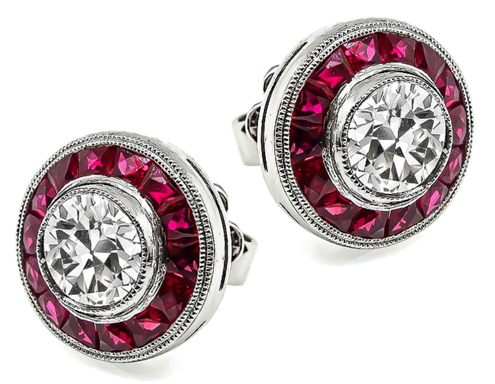 This amazing pair of platinum earrings feature sparkling round cut diamonds that weigh 1.29ct. graded H-I color with VS clarity. The diamonds are accentuated by lovely faceted calibre cut rubies that weigh approximately 1.00ct.
The earrings measure