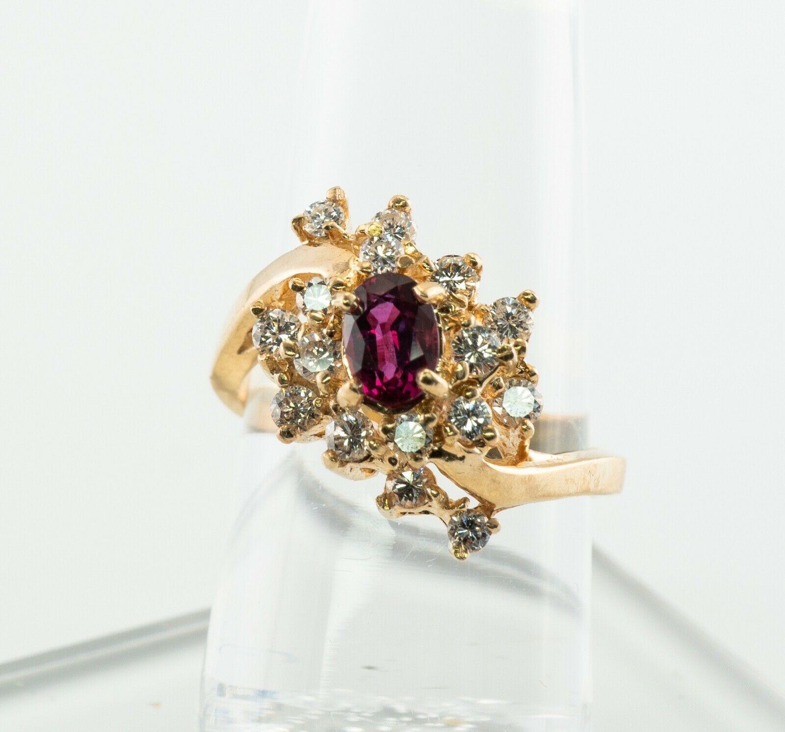 This lovely estate ring is finely crafted in solid 14K Yellow Gold and set with natural Earth mined Rubellite and diamonds. The center oval cut stone measures 6mm x 4mm (.60 carat). This is a very clean and transparent gem of great intensity and