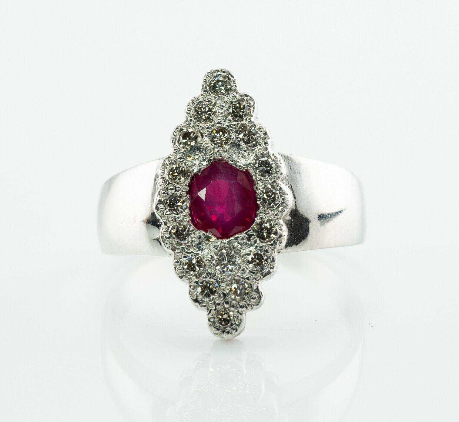 This absolutely stunning vintage ring is finely crafted in solid 14K White gold and set with Natural Earth-mined Ruby and diamonds. The center red Ruby measures 5mm x 4mm (.52 carat) and this is a very clean and transparent gem of great intensity