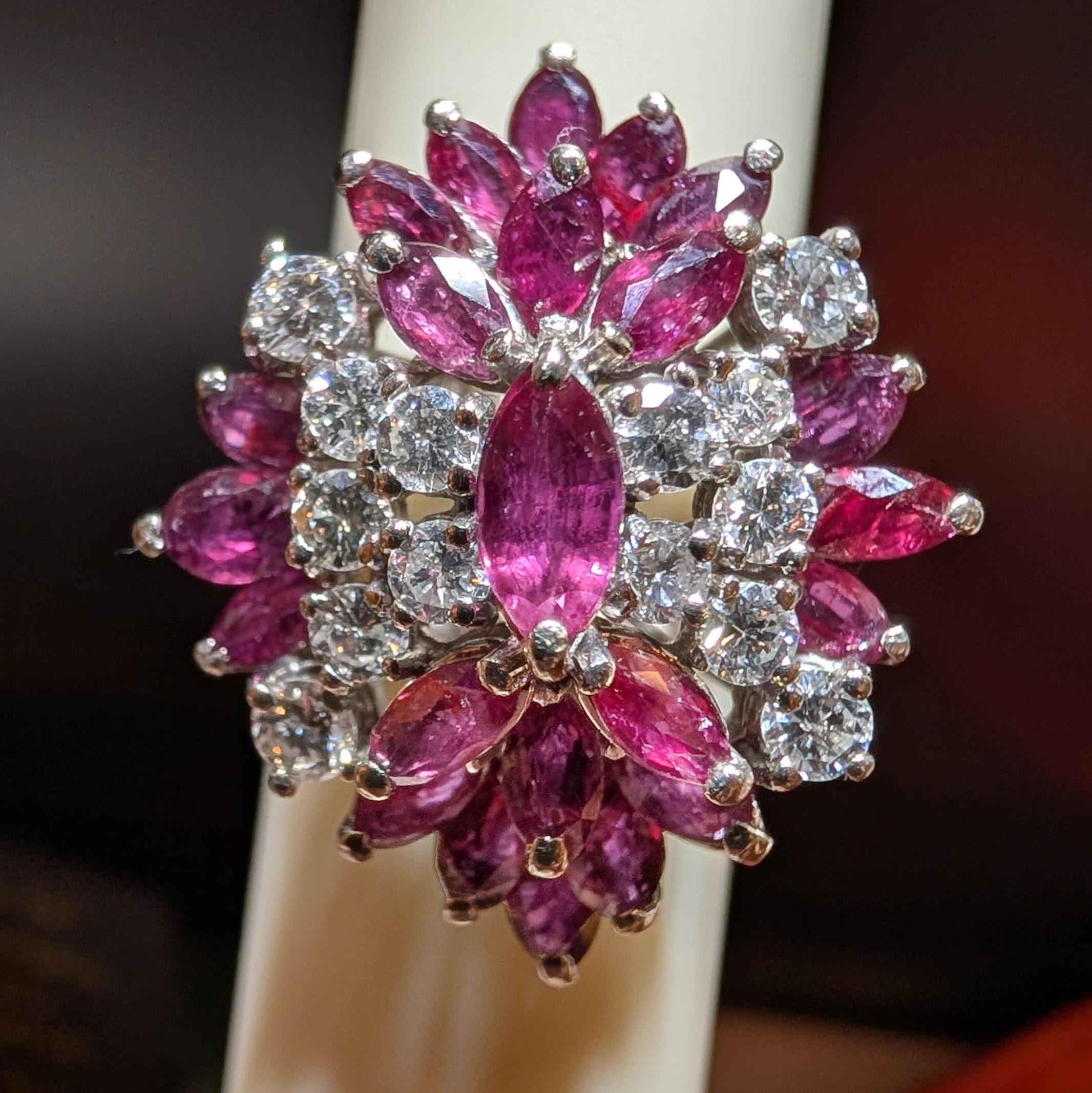 Perfectly, outrageously flashy, and fun, this Midcentury (circa 1950s) cocktail ring is bursting with marquise-cut rubies and round brilliant diamonds. There are 3.30 carats of rubies and 1.08 carats of bright white diamonds for a total carat weight