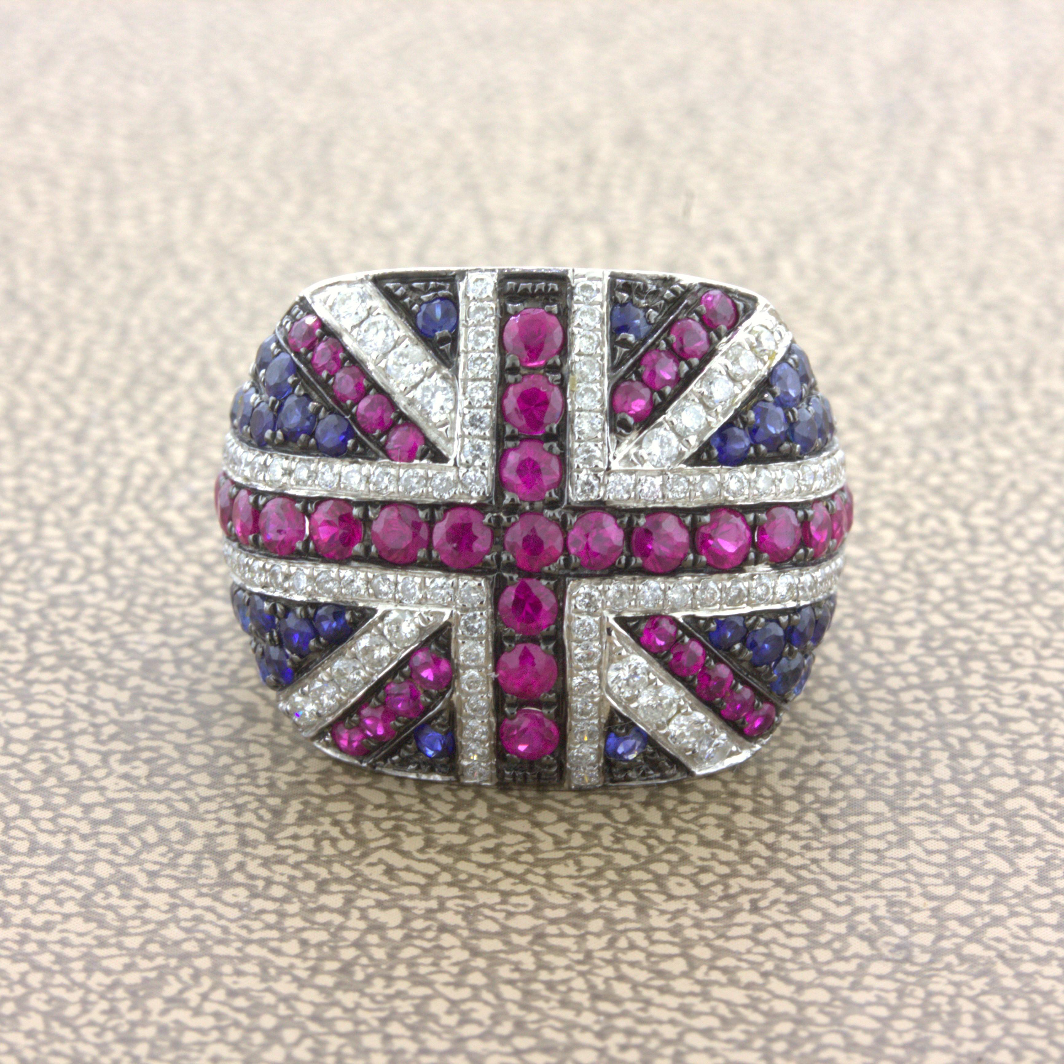 A lovely ring designed as the flag of the United Kingdom, the Union Flag. It features 1.25 carats of bright red rubies, 0.75 carats of vivid blue sapphires, and 0.55 carats of round brilliant-cut diamonds. Made in 18k white gold, this stylish piece