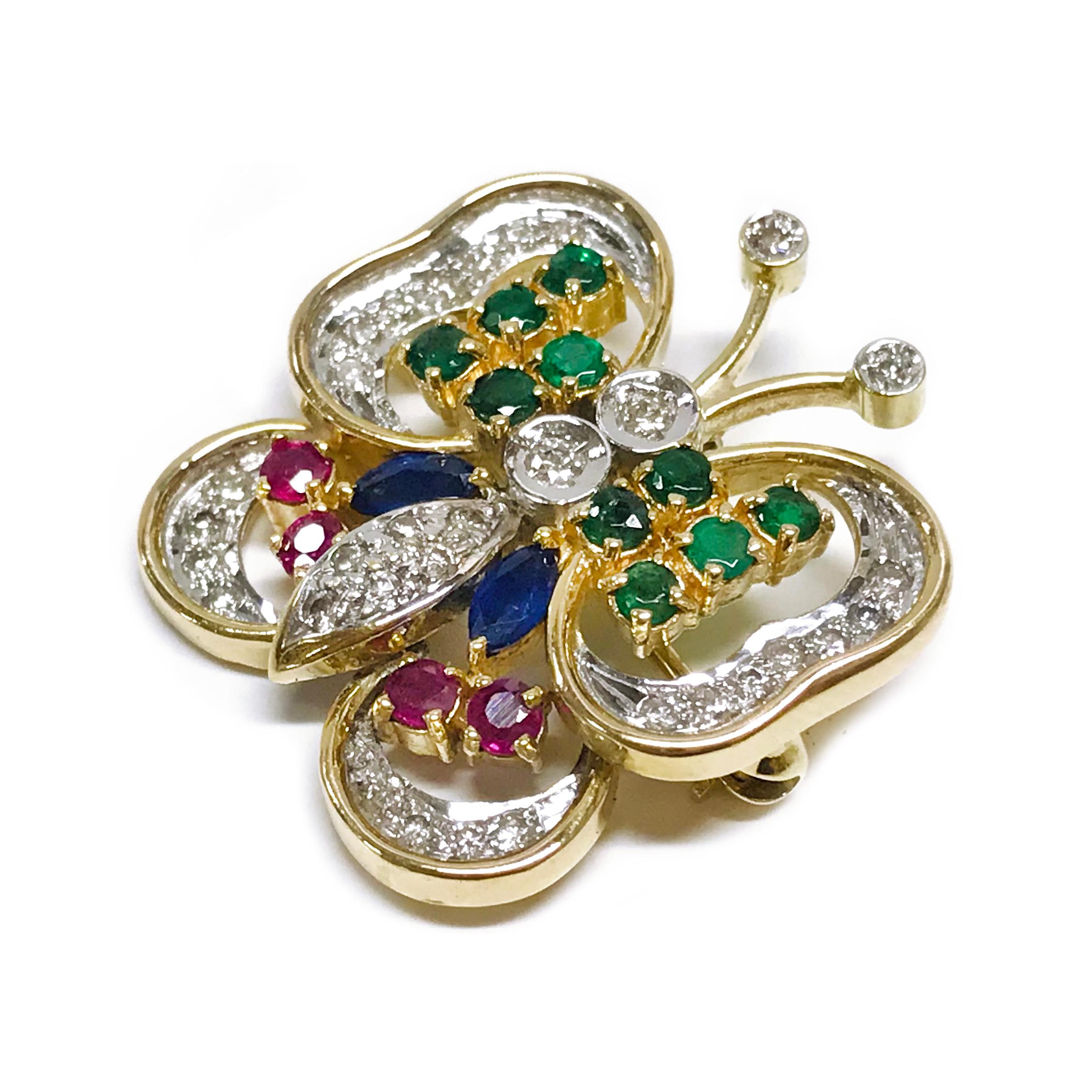 Diamond Ruby Sapphire Emerald Butterfly Brooch/Pin. This lovely little fella features ten round emeralds, two marquise blue sapphires, four round rubies, and thirty-four round diamonds. The color gemstones are all prong-set and the diamonds are