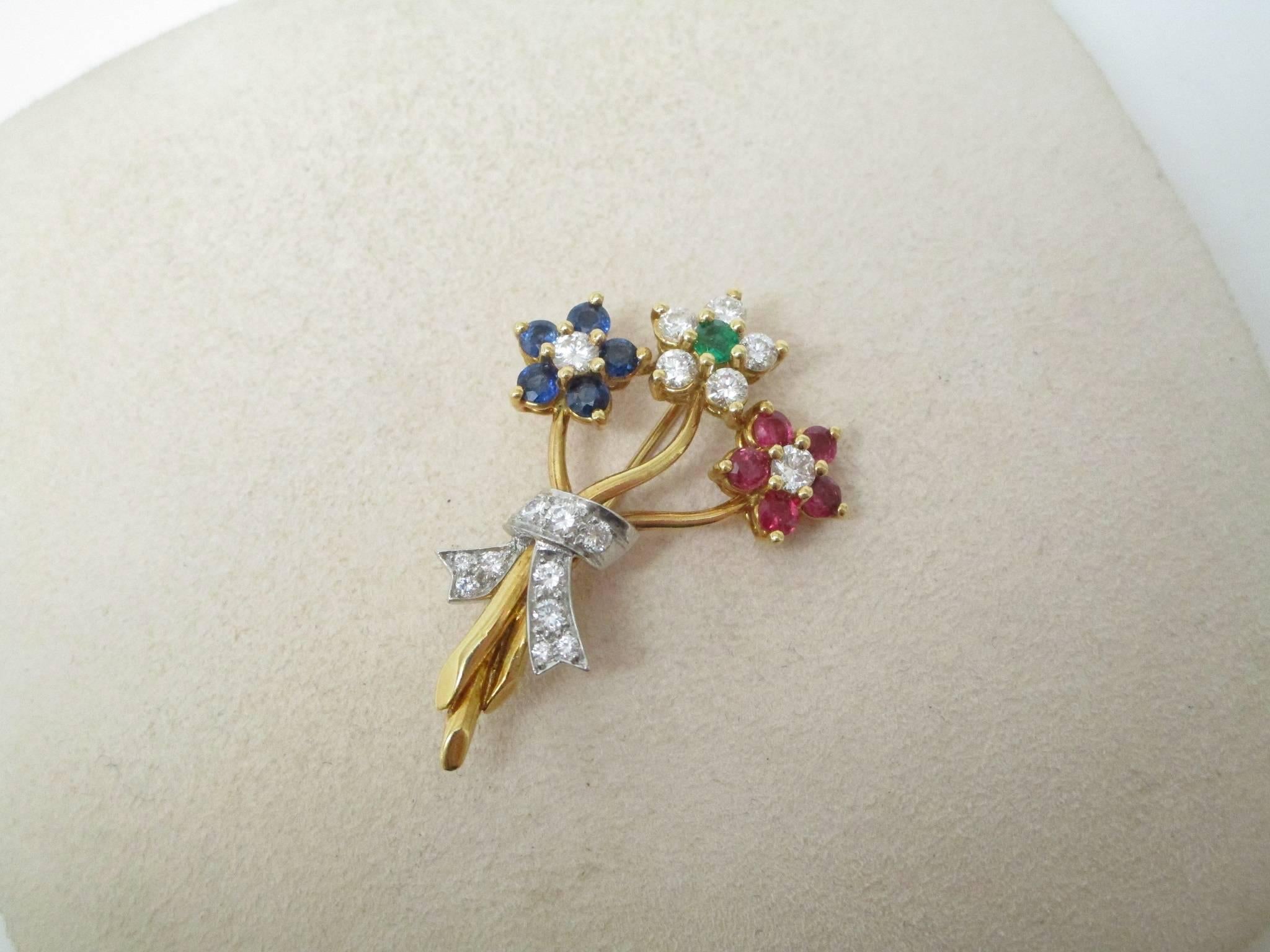 This lovely pin features three blooms of Ruby, Sapphire, Emerald, and Diamonds, all nestled in 18K white and yellow gold. This is great way to give flowers that will never fade. Mothers love to get posies, for Mother's Day or just because it's