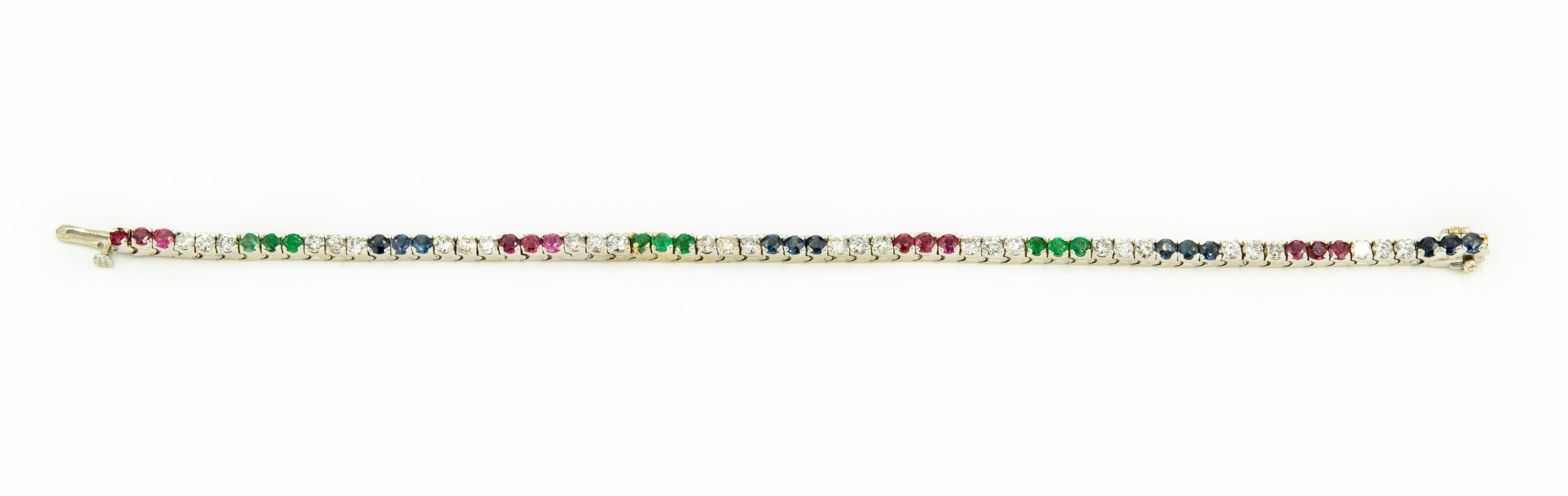 Classic line or tennis 14k white gold line or tennis bracelet with 3 diamonds spaced between 3 rubies, emeralds or sapphires.  The clasp is a push button with a safety bar on the underside.  
