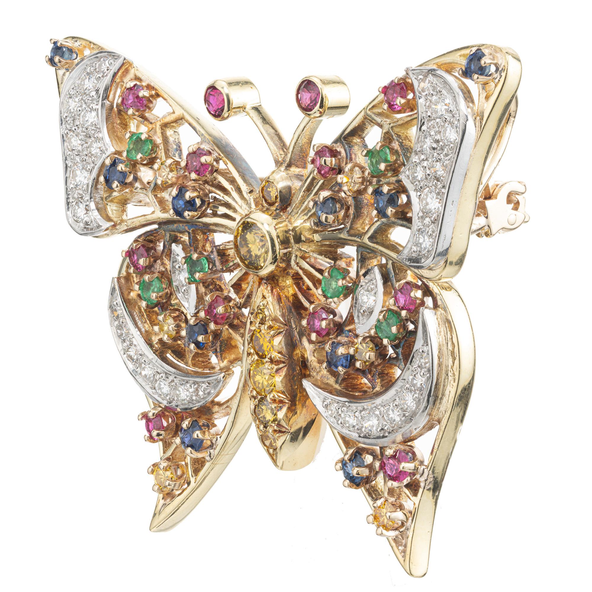 Beautiful and stunning custom made butterfly brooch and pendant. Adorned with 72 round white diamonds, 18 round cut yellow diamonds, 10 round rubies, 8 round sapphires and 6 round emeralds. The butterfly is constructed in 18k yellow gold with