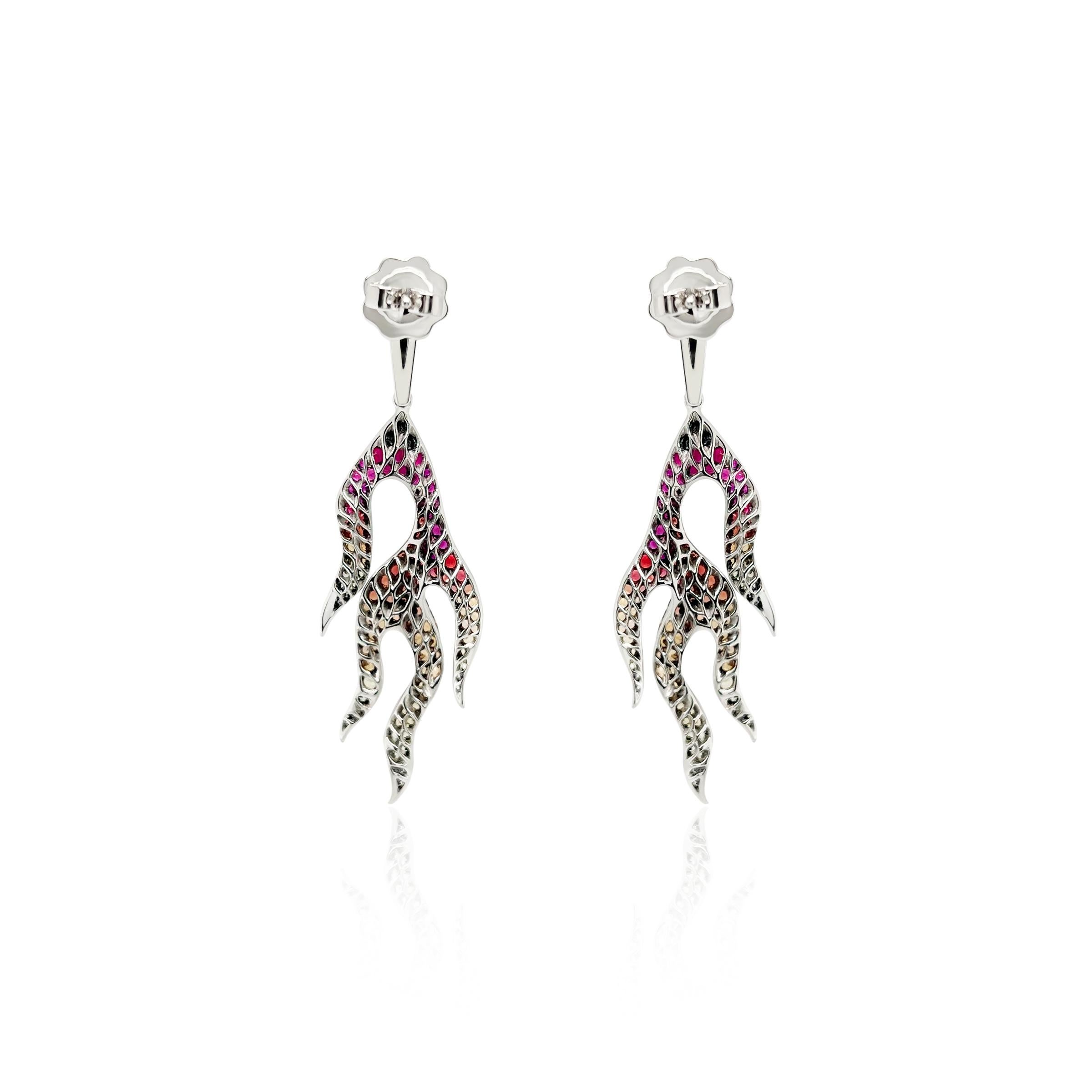 These Diamond, Ruby and Sapphire Flame Earrings are masterfully designed and set in 18k white gold with black rhodium highlights. These earrings showcase a symphony of colors that cascade with meticulously selected and arranged gemstones. The
