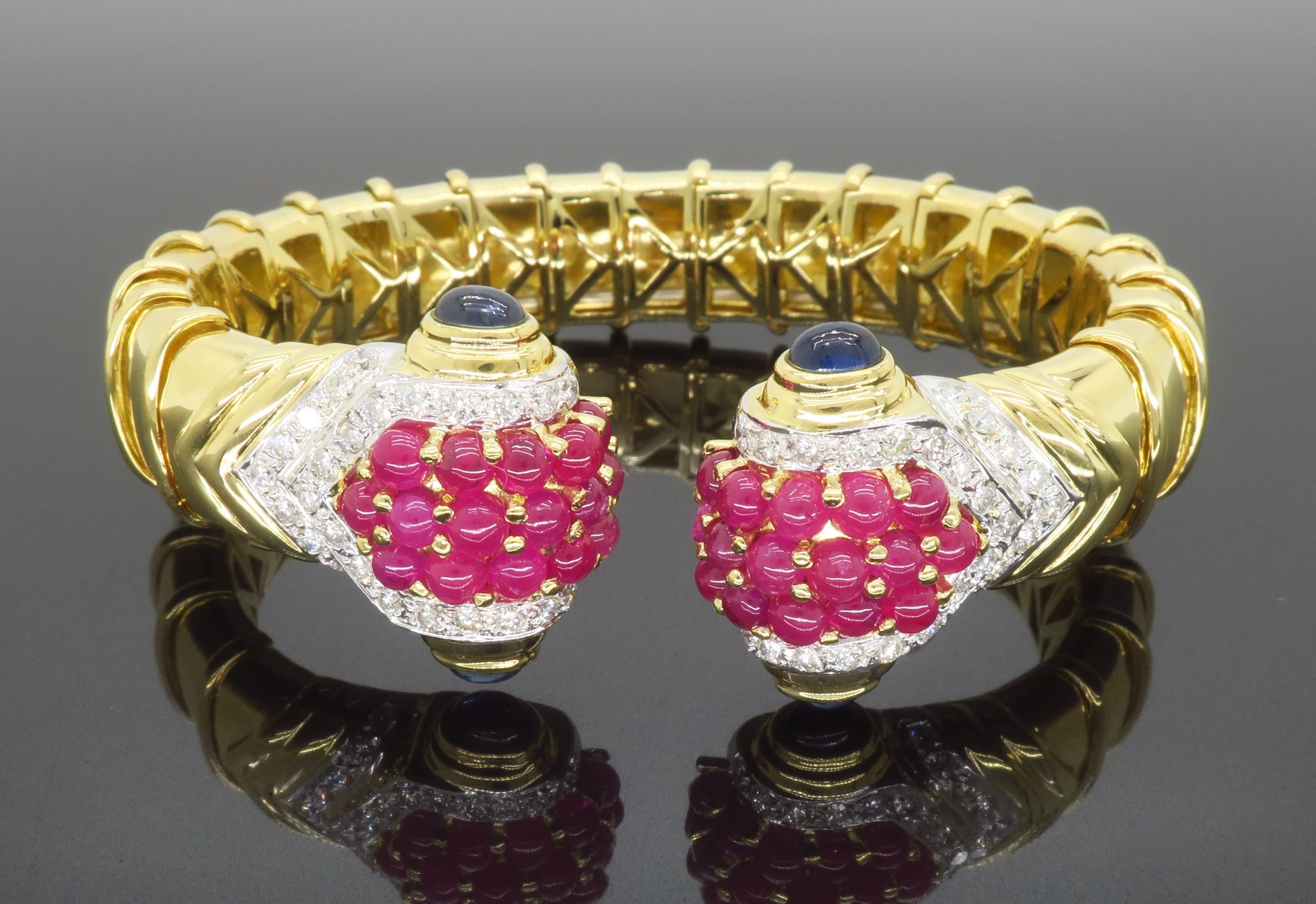 Stunning Diamond, Cabochon Ruby, and Cabochon Sapphire flex cuff bracelet crafted in 18k yellow gold. 

Gemstone: Diamond, Ruby, & Sapphire
Diamond Carat Weight: Approximately 1.50CTW
Diamond Cut: Round Brilliant Cut
Average Diamond Color: