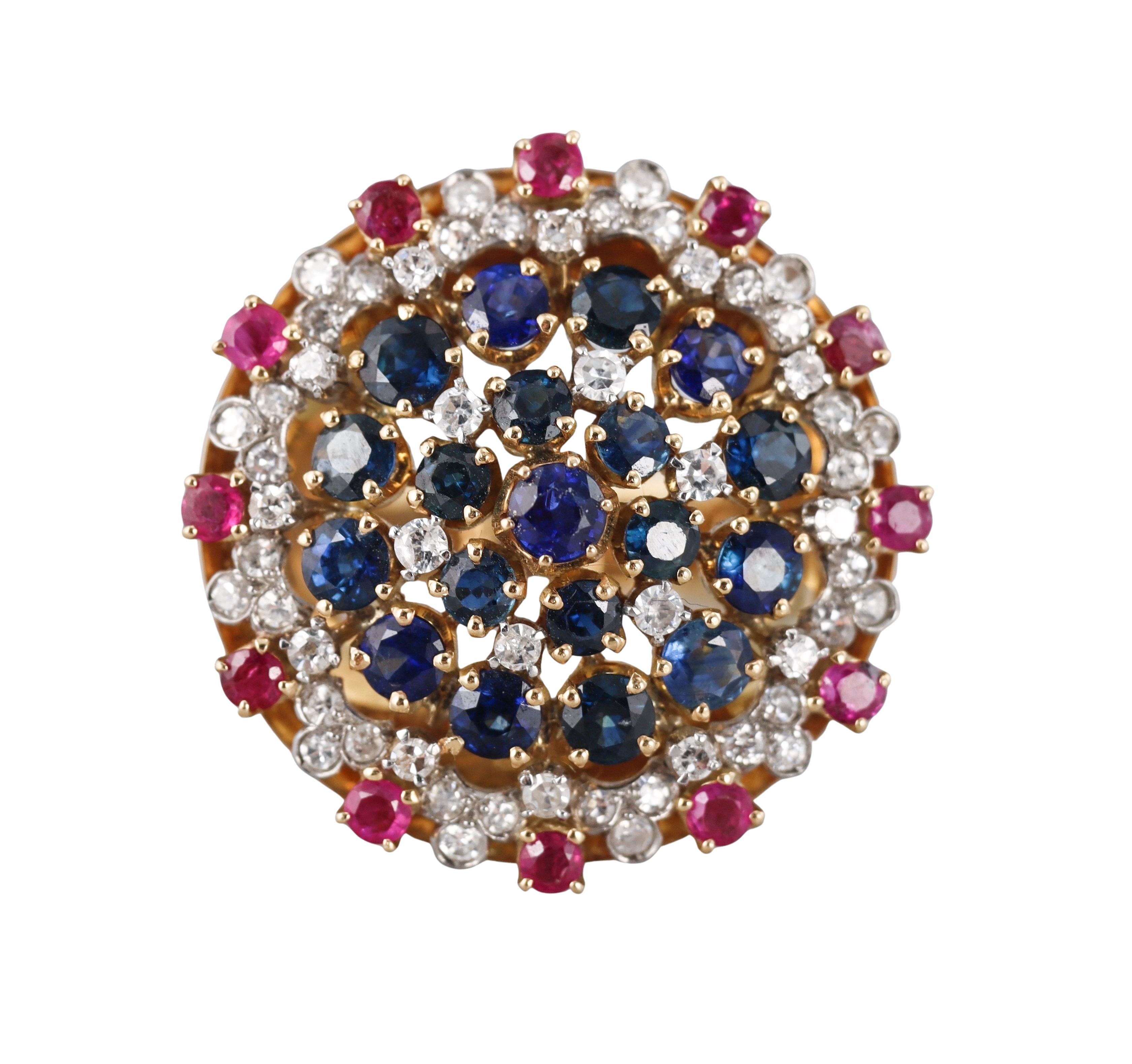 An 18k yellow gold cocktail ring, featuring sapphires, rubies and approx. 1.80ctw in H-I/SI diamonds. 
Ring size 7.75, top is 35mm in diameter.
Marked 750.
Weight - 26.6 grams.