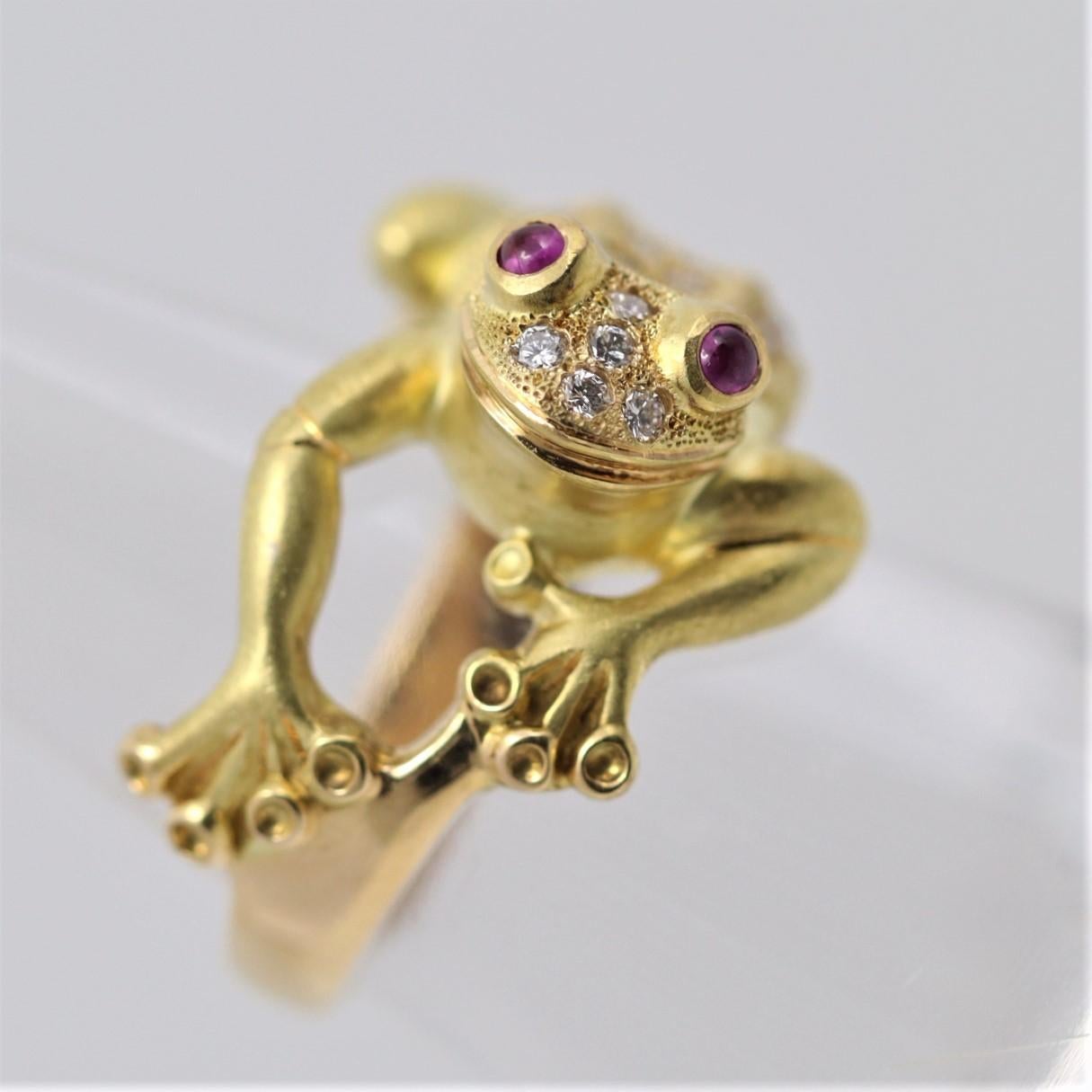 A whimsical and playful ring featuring a lifelike frog studded with diamonds and ruby eyes. The stretched frog features 0.46 carats of round brilliant-cut diamonds set on its back, along with two ruby cabochons as its eyes. Its body is crafted in