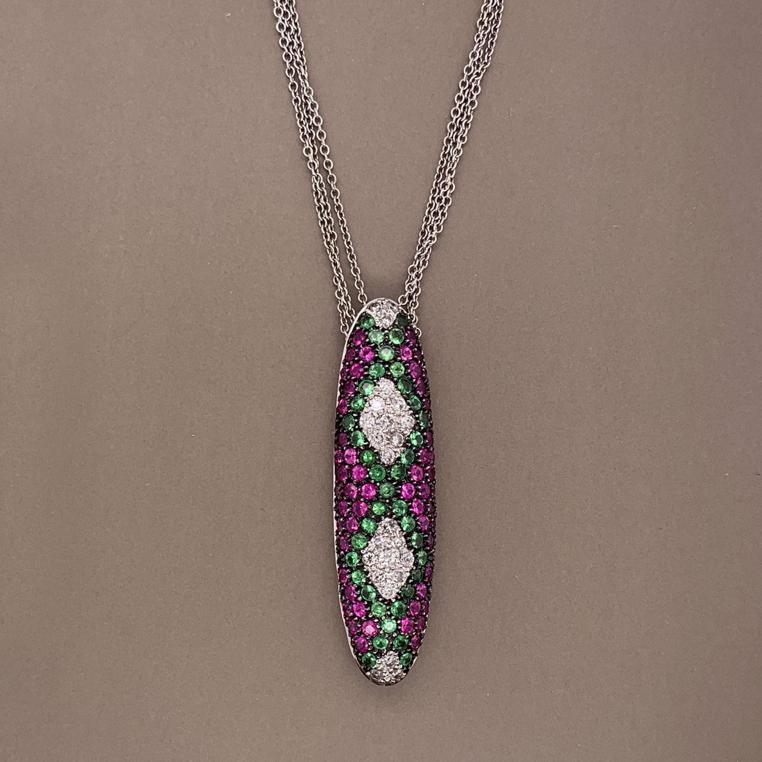This stylish necklace features diamonds rubies and tsavorite set in a mosaic pattern. The diamonds weigh a total of 0.60 carats, the rubies 1.50 carats and the tsavorite 1.30 carats. They are all set in 18k white gold with black rhodium finish on