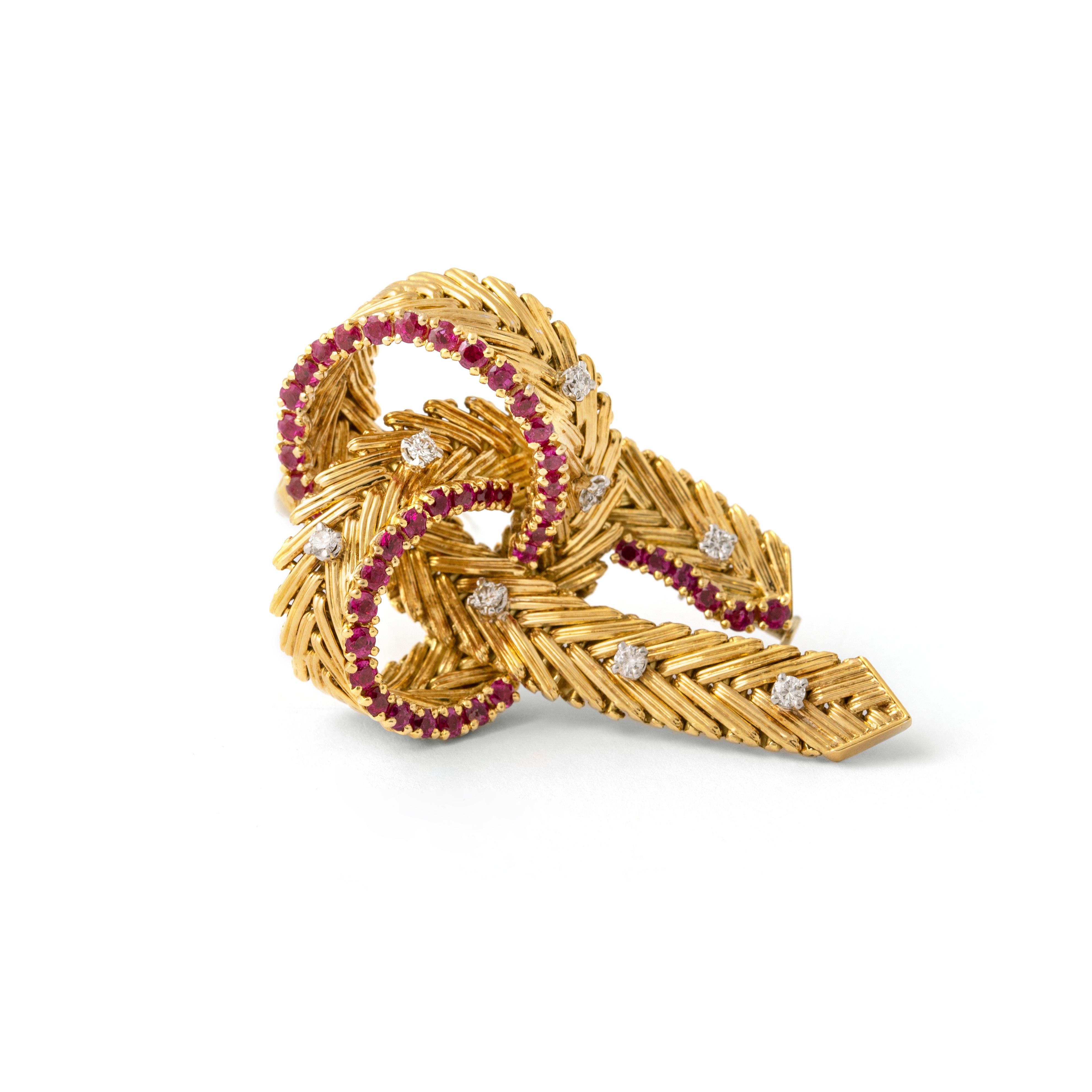 Diamond and Ruby on Yellow Gold 18K Brooch.
Marked EM.
Circa 1960.

Total length: approx. 5.20 centimeters / 2.05 inches.
Total width: approx. 3.30 centimeters / 1.30 inches.

Total weight: 29.97 grams.
