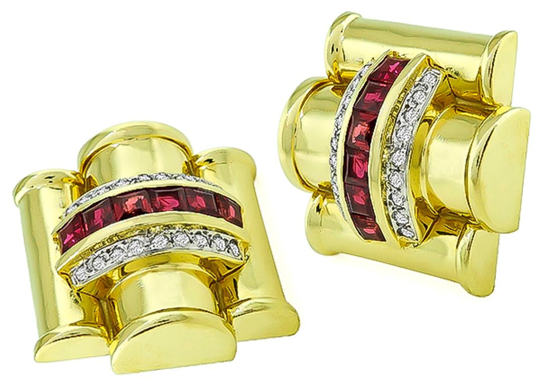 This charming pair of 14k yellow gold earrings feature sparkling round cut diamonds that weigh approximately 1.00ct. graded G color with VS clarity. The diamonds are accentuated by lovely ruby accents. The earrings measure 23mm by 23mm and weigh