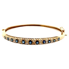 Bracciale a cerniera con diamante e zaffiro in oro giallo 14 carati