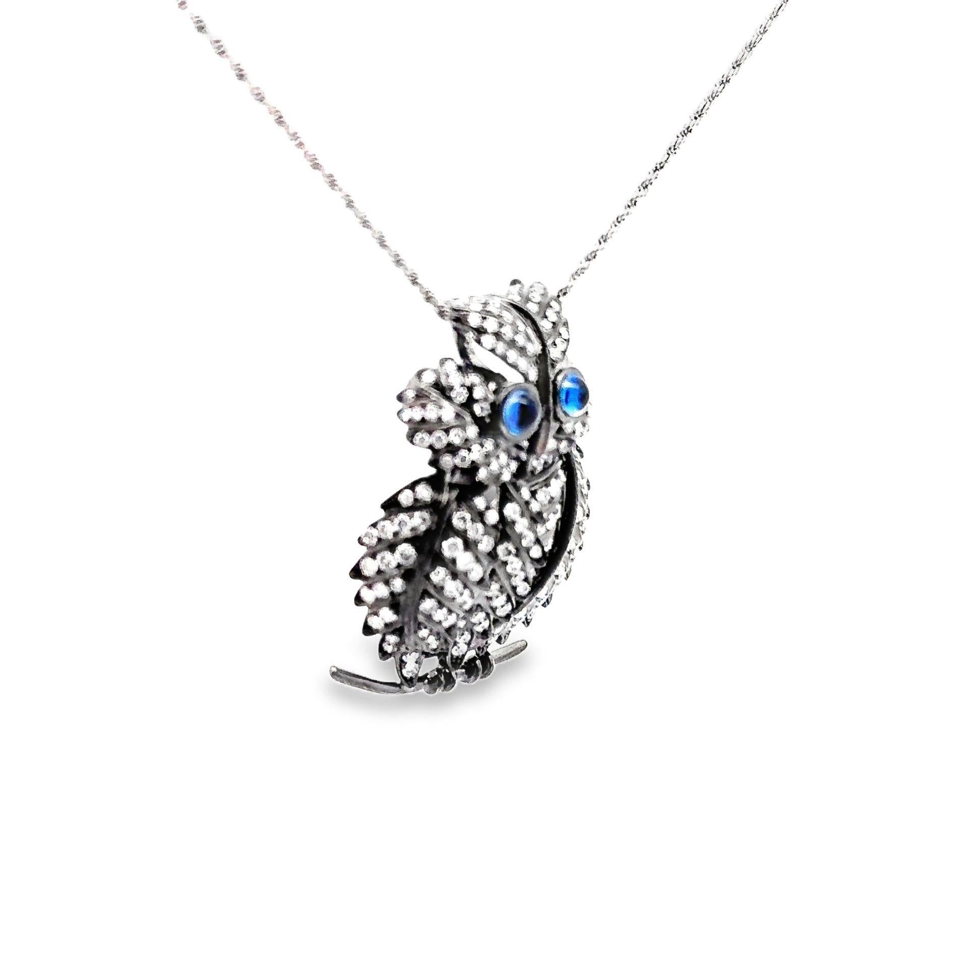 A striking pendant necklace featuring a meticulously crafted friendly owl. The owl is adorned with round white diamonds, totaling 2.90 carats, which shimmer across its intricately detailed feathers. Its eyes are highlighted by cabochon-cut blue